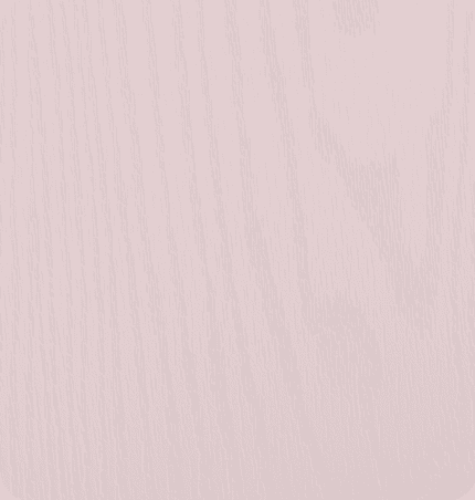 A light pink wooden surface with visible wood grain texture.
