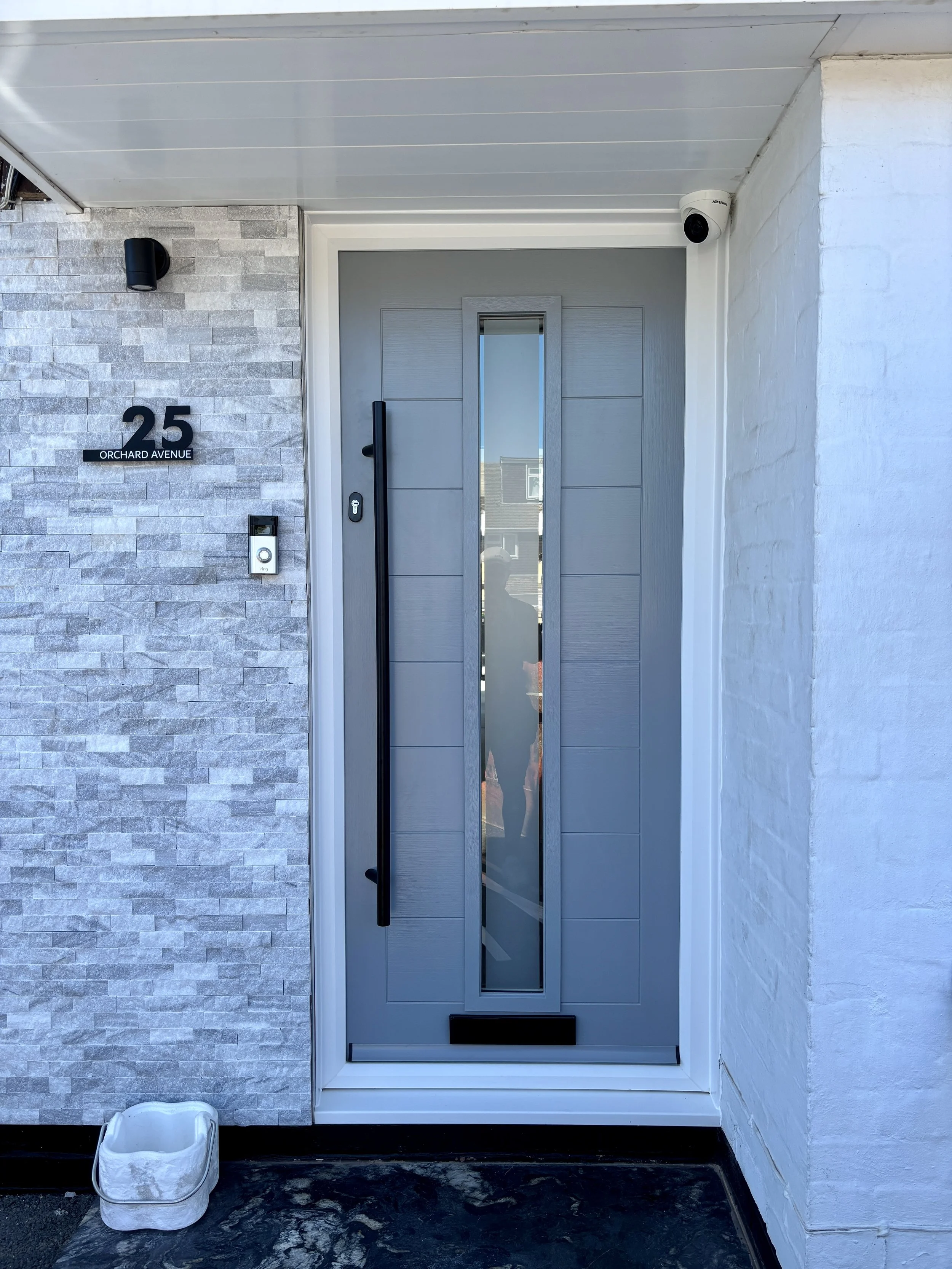 grey front composite door with black handle