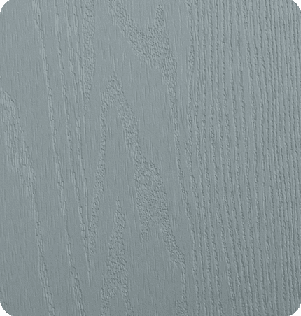 Close-up of a light gray, textured wooden surface with visible grain patterns.