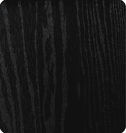 Close-up of a dark, textured wooden surface with visible grain patterns.