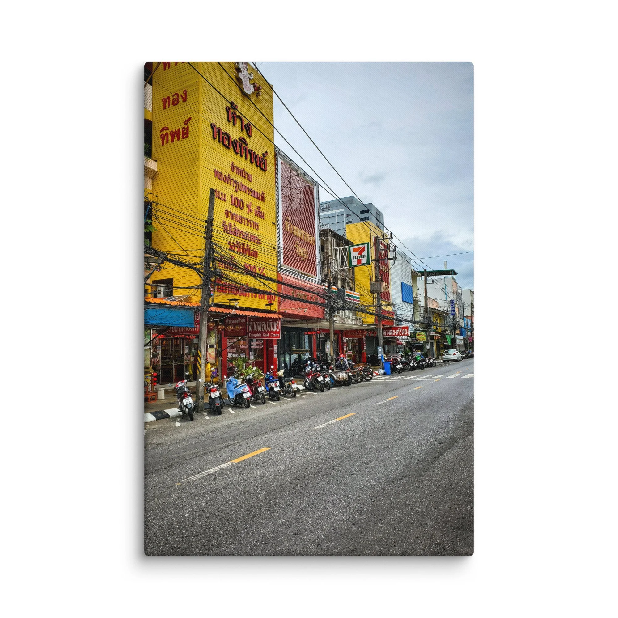 Vibrant Thai street with gold shops, colorful buildings, parked scooters and overhead wires – authentic Thailand travel photography canvas print wall art decor