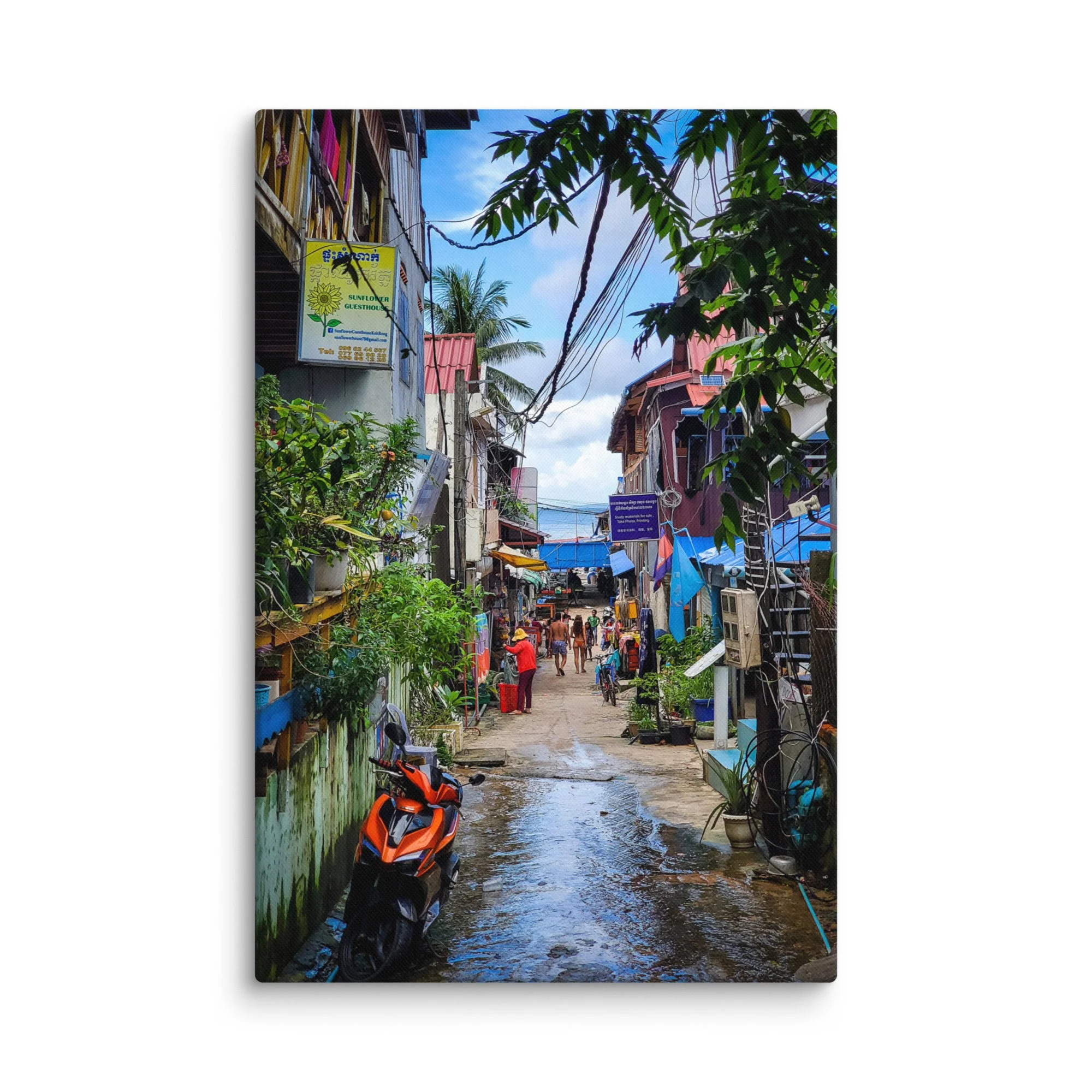 Charming Koh Rong island alley with Sunflower Guesthouse, colorful buildings, scooters and wet path after rain – tropical Cambodia travel photography canvas print wall art decor