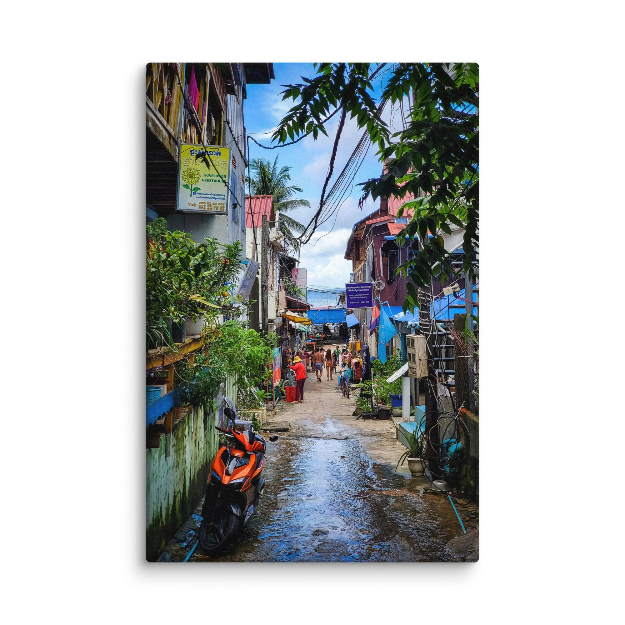 Charming Koh Rong island alley with Sunflower Guesthouse, colorful buildings, scooters and wet path after rain – tropical Cambodia travel photography canvas print wall art decor