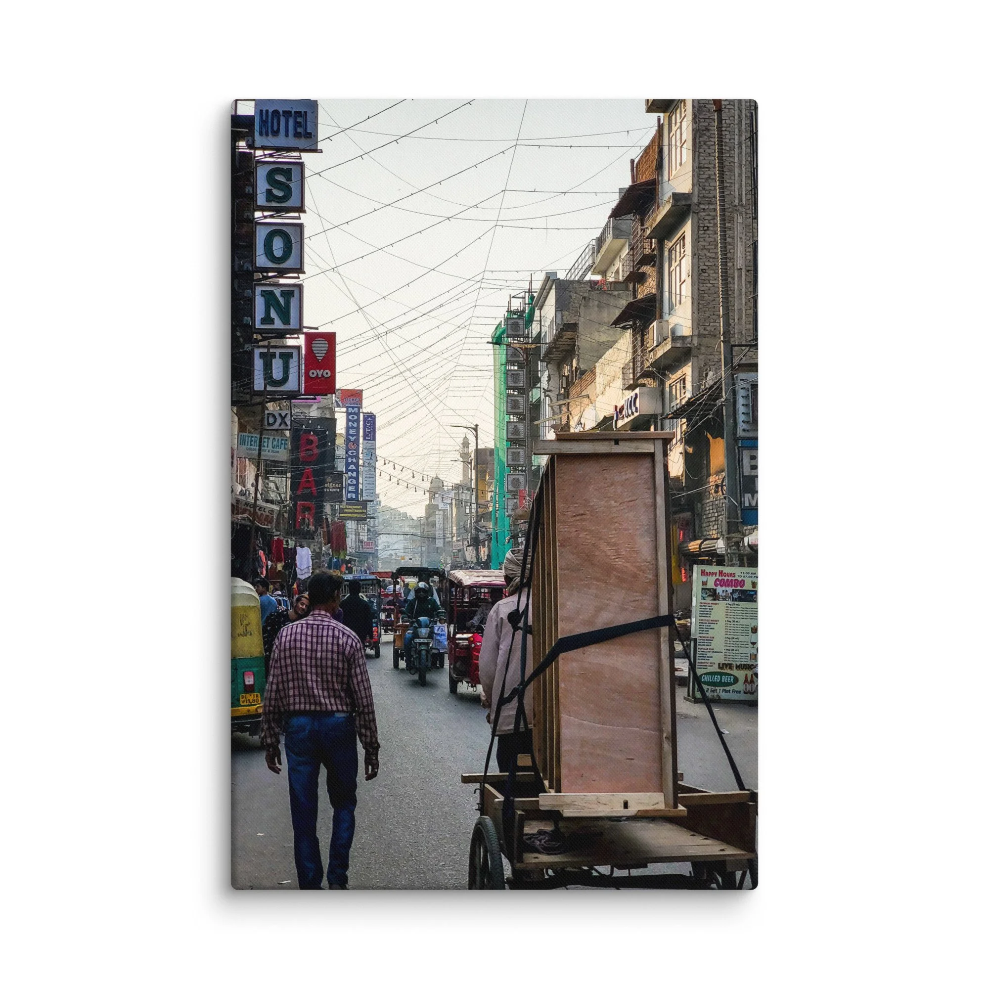 Vibrant Varanasi street with Hotel Sonu sign, overhead wires, carts, tuk-tuks and bustling life – authentic India travel photography canvas print wall art decor