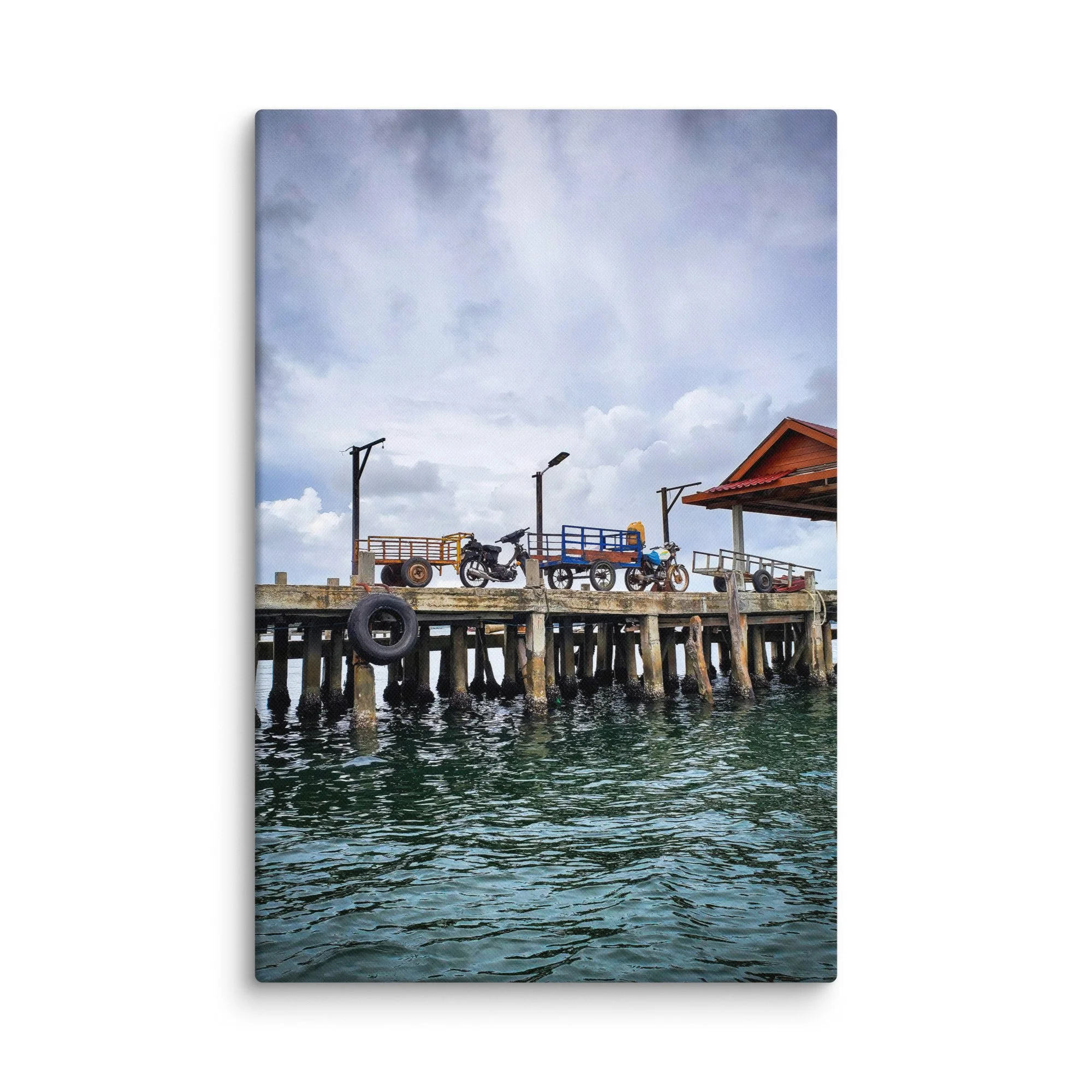 Authentic Koh Rong island wooden pier with scooters, cargo carts and calm green water under overcast sky – Cambodia travel photography canvas print wall art decor