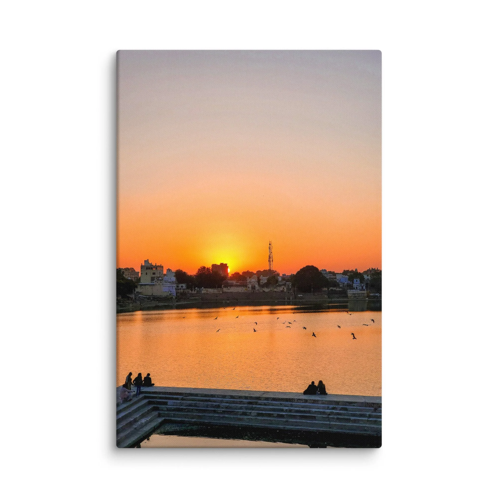 Serene sunset over Pushkar Lake with pilgrims on ghats, birds flying and warm orange sky reflection – sacred Rajasthan India travel photography canvas print wall art decor