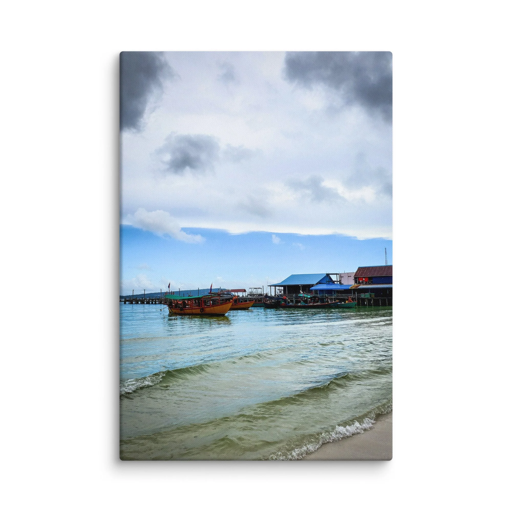 Serene Thai island pier with colorful longtail boats, gentle waves and green hills under cloudy sky – authentic Thailand travel photography canvas print wall art decor
