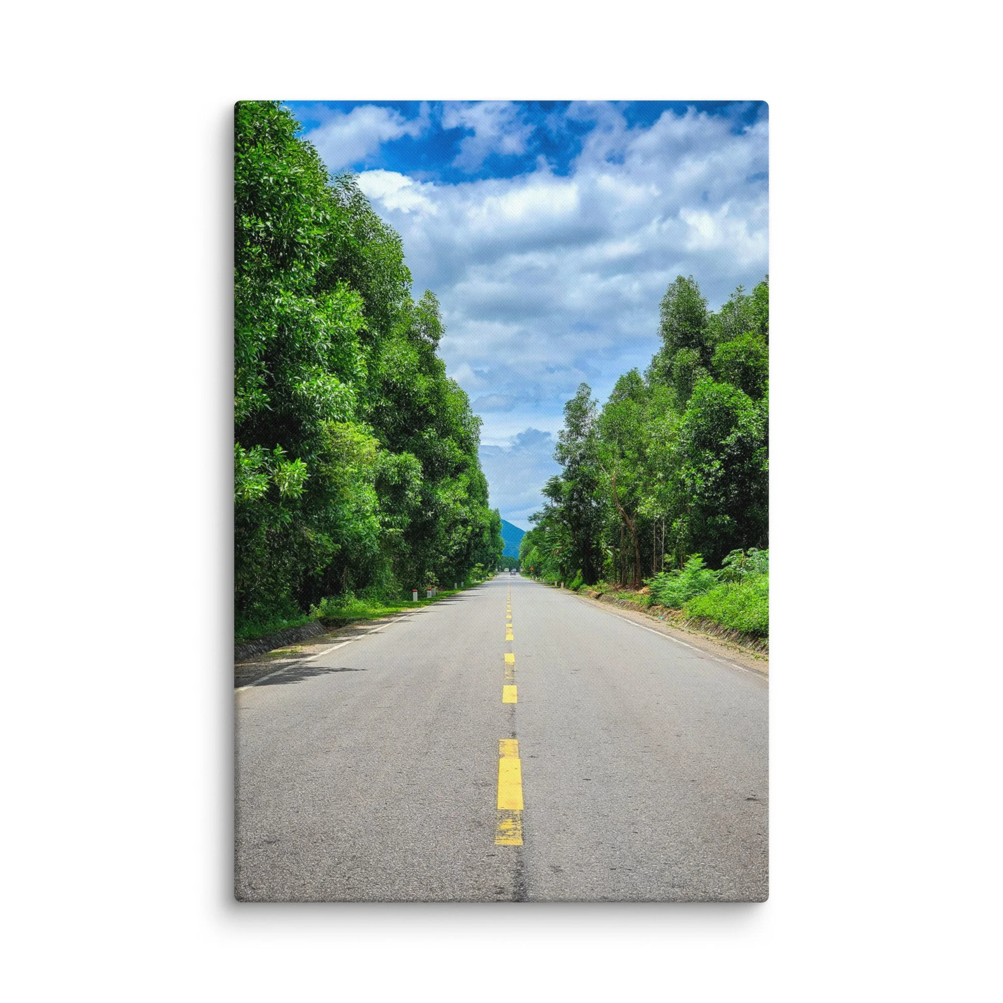 Serene northern Thailand highway lined with lush green trees under bright blue sky and distant mountains – travel photography canvas print wall art decor