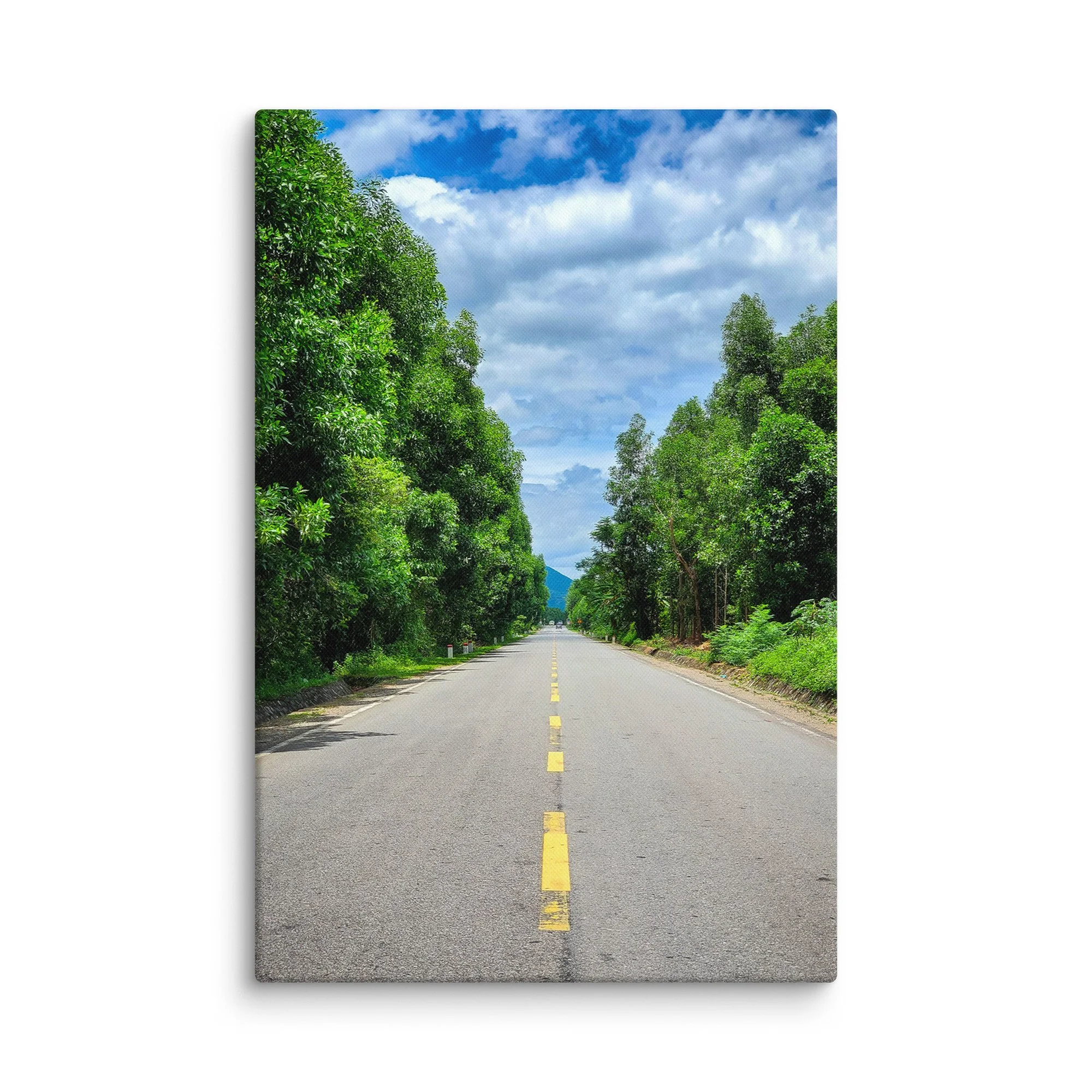 Serene northern Thailand highway lined with lush green trees under bright blue sky and distant mountains – travel photography canvas print wall art decor