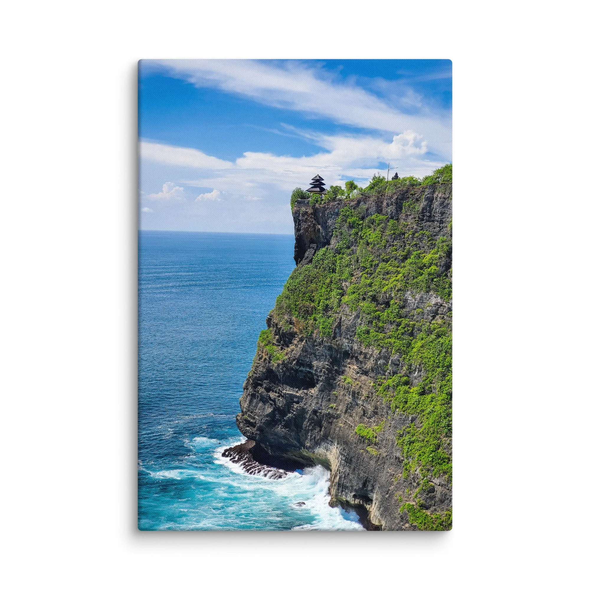 Uluwatu Temple on dramatic cliffs overlooking turquoise ocean in Bali, Indonesia under blue sky – sacred travel photography canvas print wall art decor