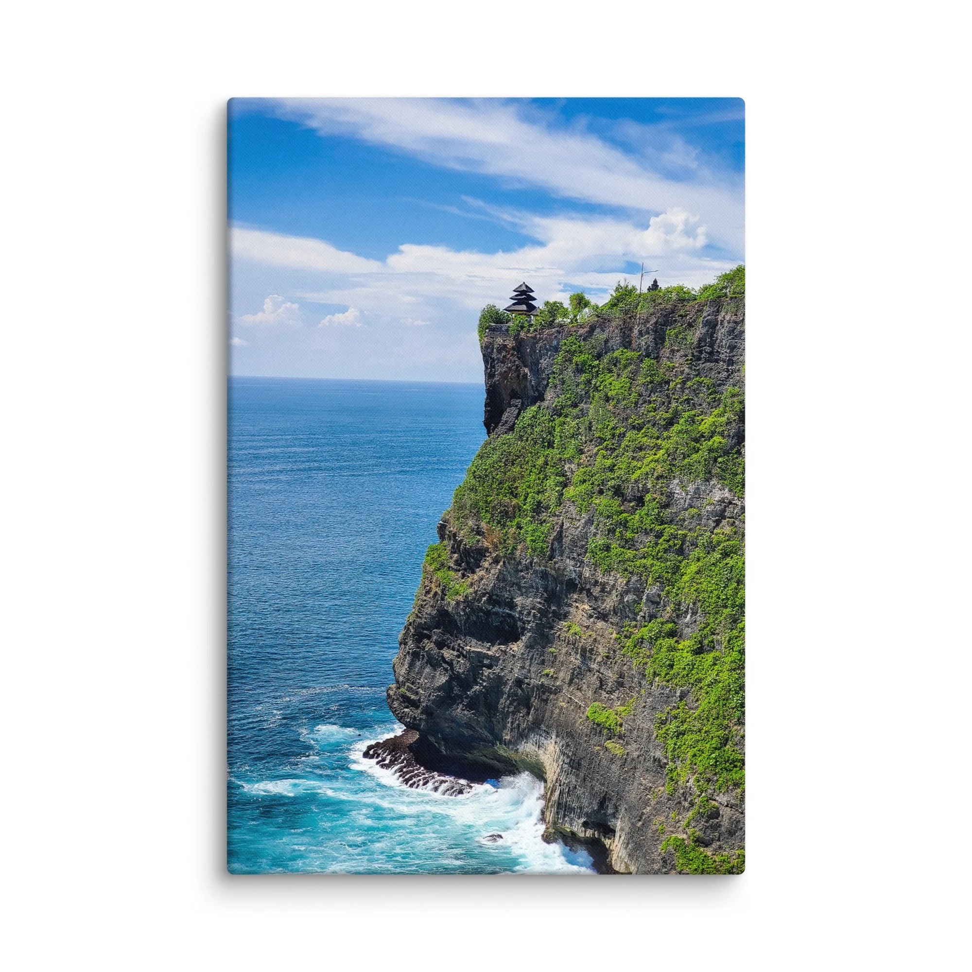 Uluwatu Temple on dramatic cliffs overlooking turquoise ocean in Bali, Indonesia under blue sky – sacred travel photography canvas print wall art decor