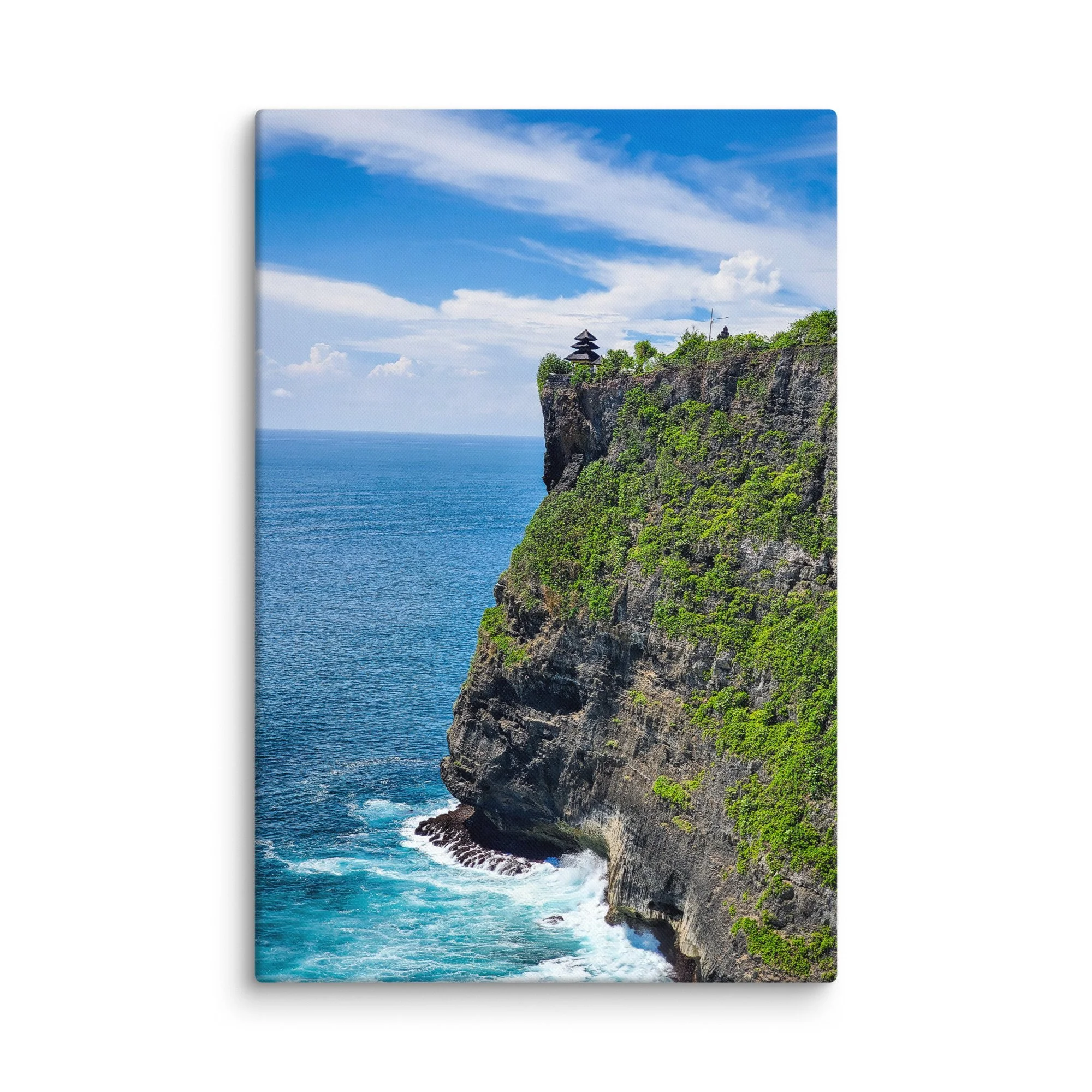 Uluwatu Temple on dramatic cliffs overlooking turquoise ocean in Bali, Indonesia under blue sky – sacred travel photography canvas print wall art decor