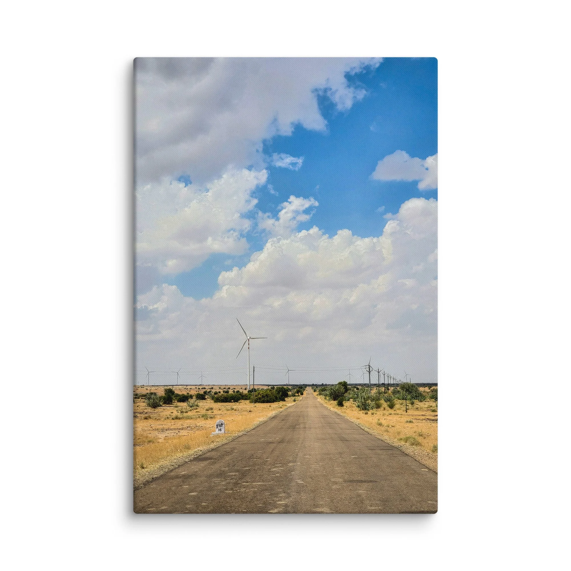 Long straight road through Rajasthan desert with rows of wind turbines under vast blue sky with clouds – Thar adventure travel photography canvas print wall art decor