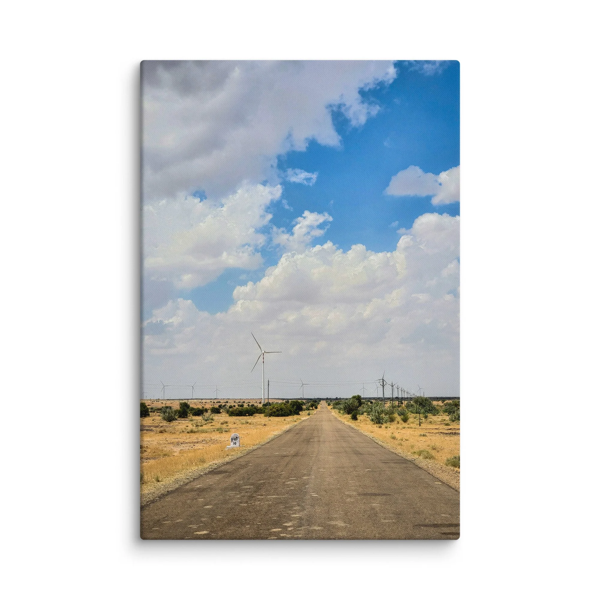 Long straight road through Rajasthan desert with rows of wind turbines under vast blue sky with clouds – Thar adventure travel photography canvas print wall art decor