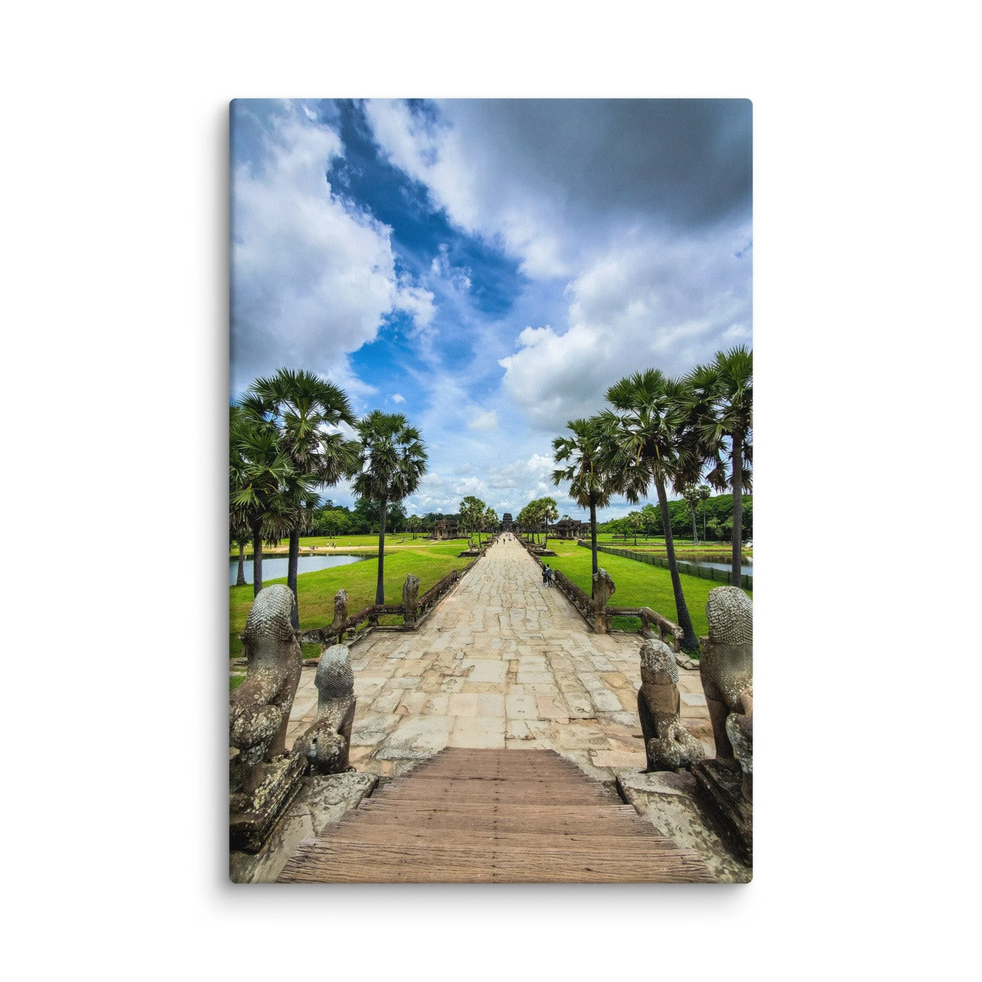 Iconic stone causeway leading to Angkor Wat temple with naga statues, reflecting pools and dramatic sky in Siem Reap, Cambodia – heritage travel photography canvas print wall art decor