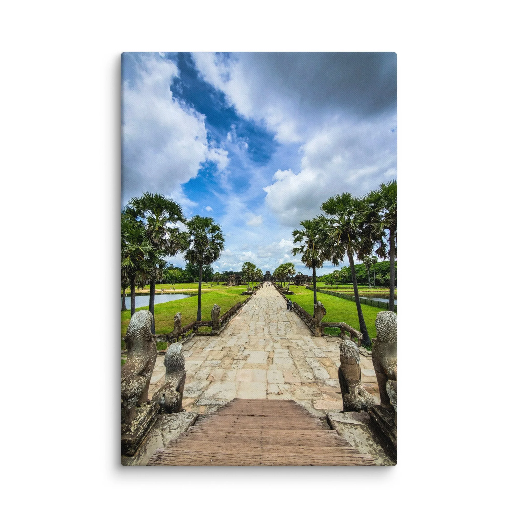 Iconic stone causeway leading to Angkor Wat temple with naga statues, reflecting pools and dramatic sky in Siem Reap, Cambodia – heritage travel photography canvas print wall art decor