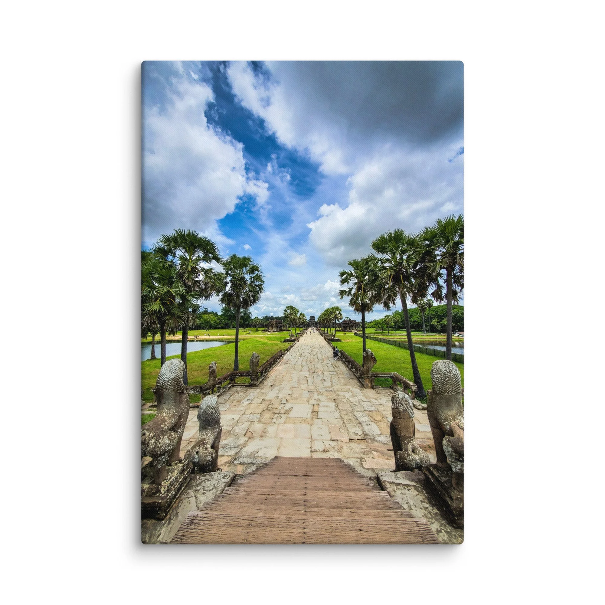 Iconic stone causeway leading to Angkor Wat temple with naga statues, reflecting pools and dramatic sky in Siem Reap, Cambodia – heritage travel photography canvas print wall art decor