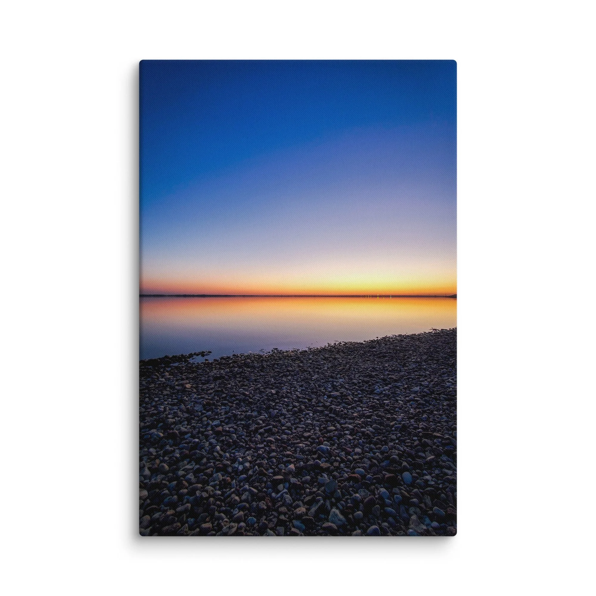 Serene pebble beach on Latvia's Baltic coast reflecting gradient sunset sky from blue to orange – Nordic travel photography canvas print wall art decor