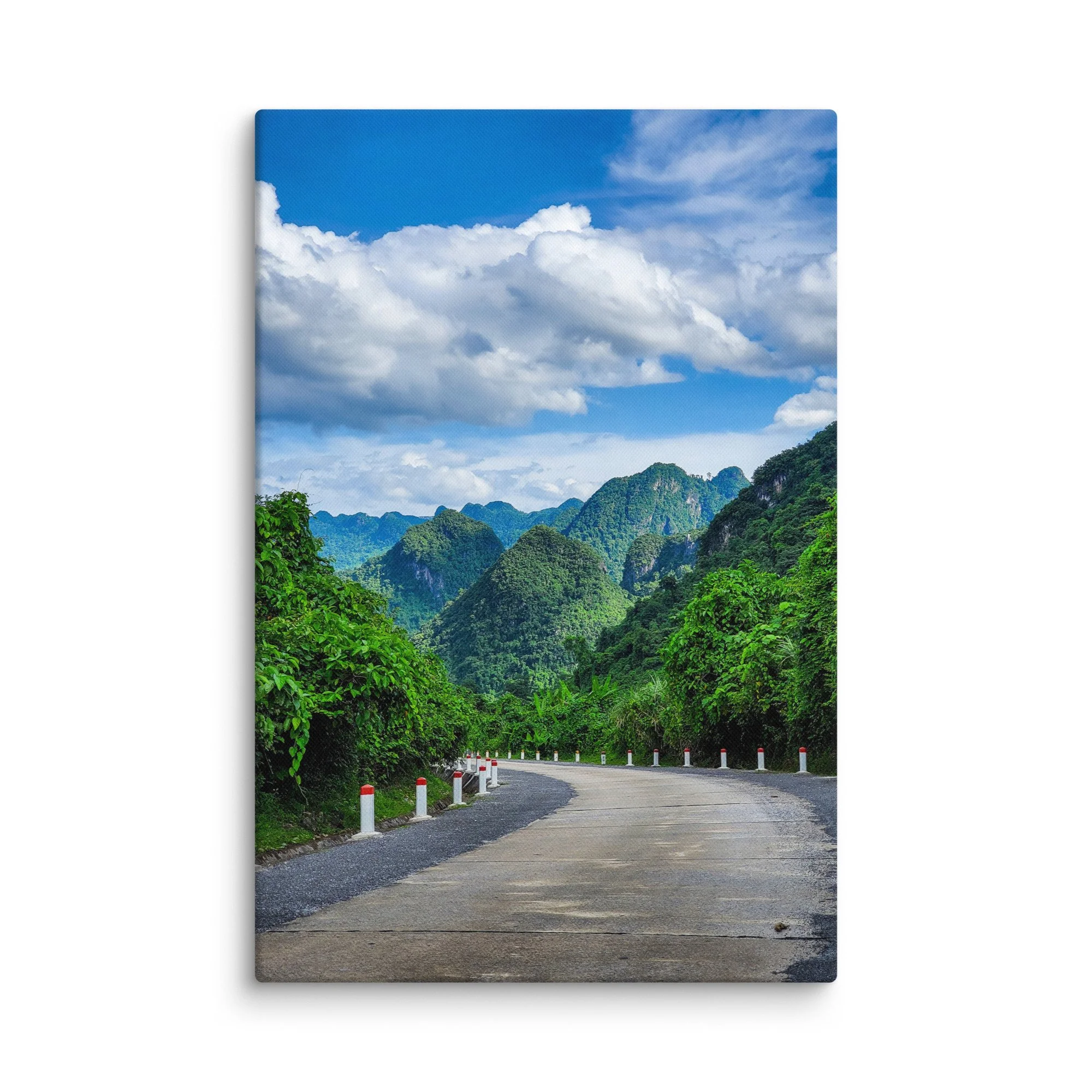 Scenic winding road through lush green karst cliffs and jungle in northern Vietnam (Hà Giang) under blue sky – adventure travel photography canvas print wall art decor