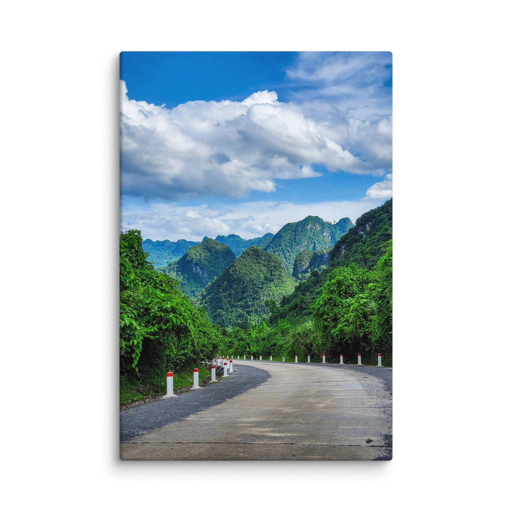 Scenic winding road through lush green karst cliffs and jungle in northern Vietnam (Hà Giang) under blue sky – adventure travel photography canvas print wall art decor