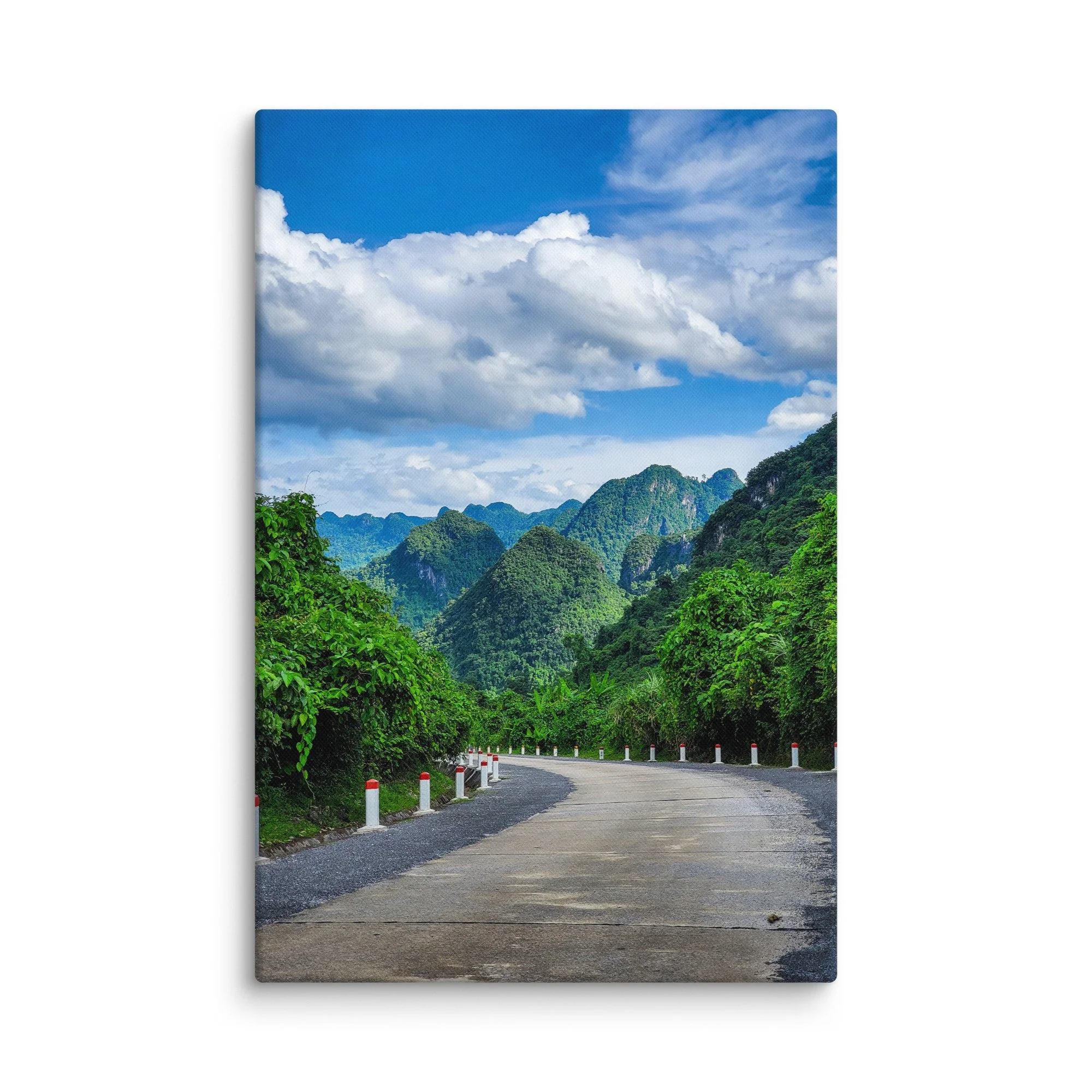 Scenic winding road through lush green karst cliffs and jungle in northern Vietnam (Hà Giang) under blue sky – adventure travel photography canvas print wall art decor