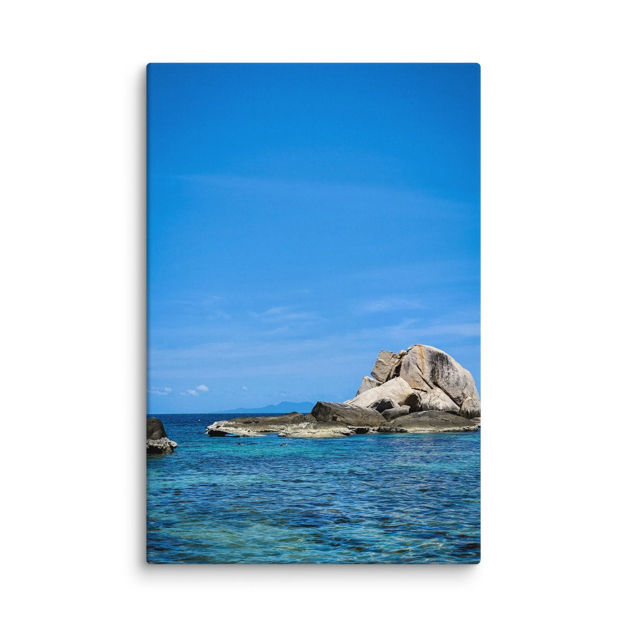 Massive smooth granite boulders rising from crystal-clear turquoise water in southern Thailand under bright blue sky – tropical travel photography canvas print wall art decor