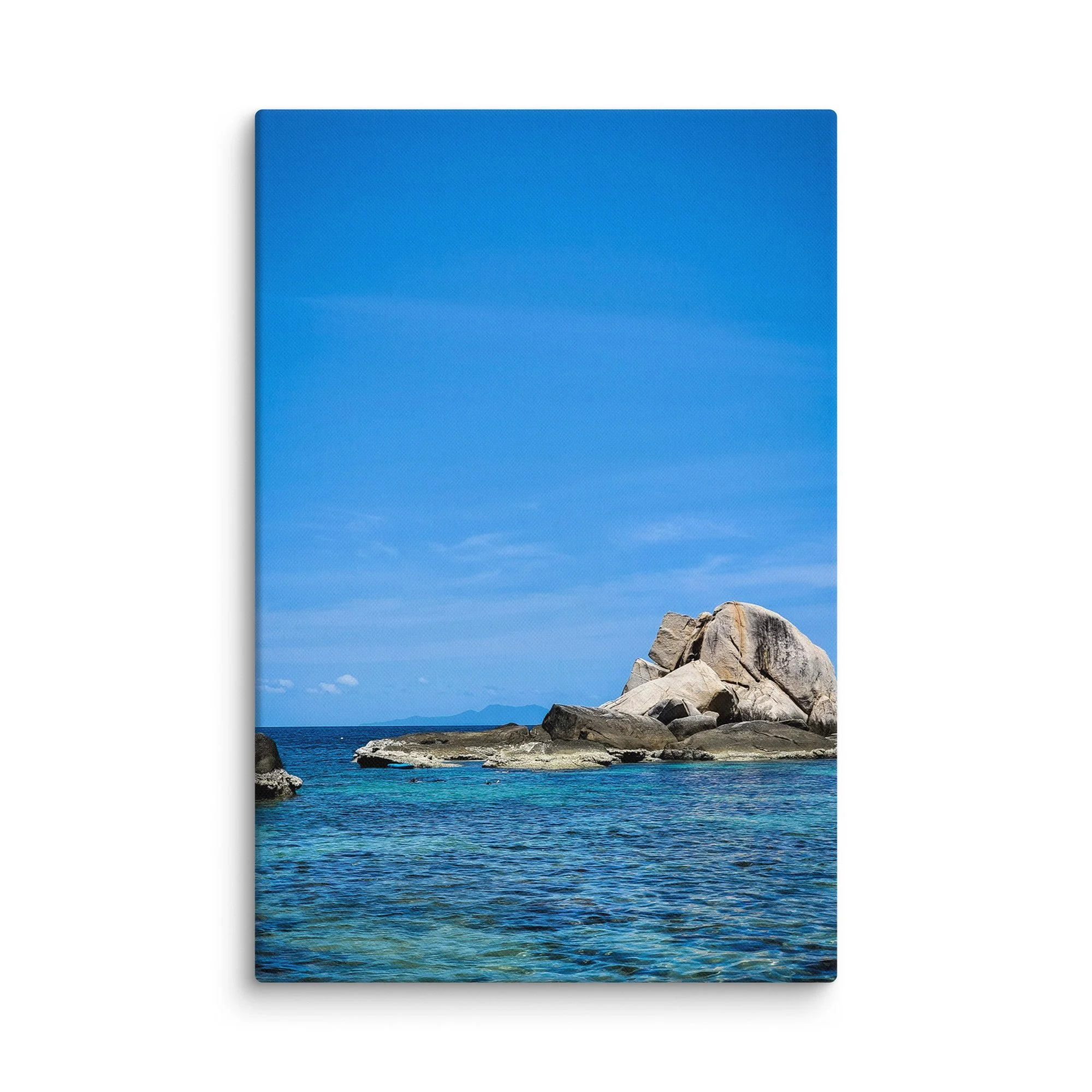 Massive smooth granite boulders rising from crystal-clear turquoise water in southern Thailand under bright blue sky – tropical travel photography canvas print wall art decor