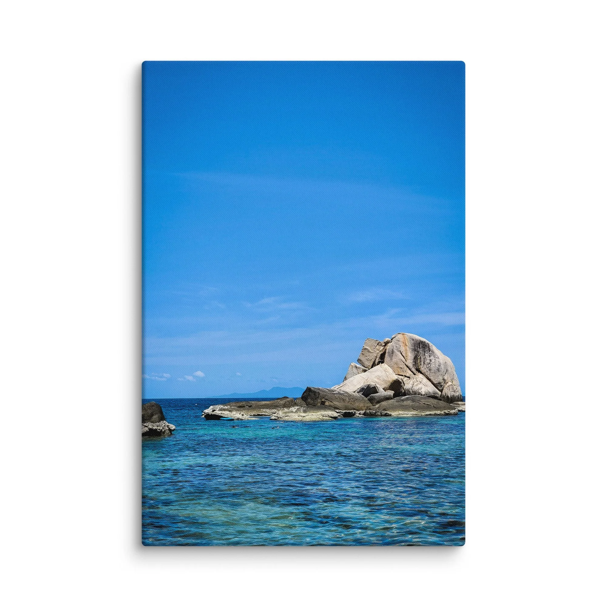 Massive smooth granite boulders rising from crystal-clear turquoise water in southern Thailand under bright blue sky – tropical travel photography canvas print wall art decor