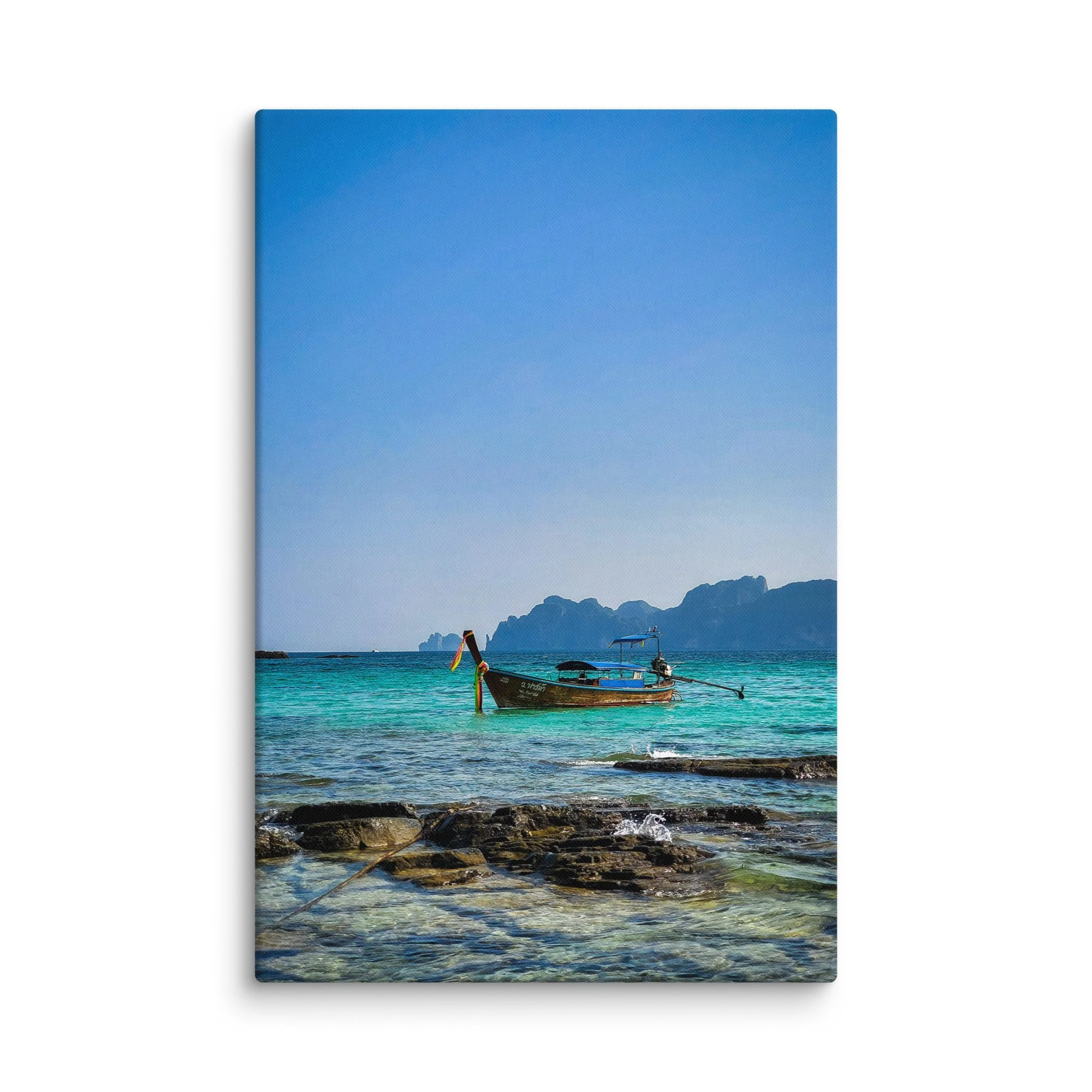 Traditional longtail boat anchored in crystal-clear turquoise waters at Railay or Phra Nang Beach, Krabi, Thailand with limestone karsts and blue sky – tropical travel photography canvas print
