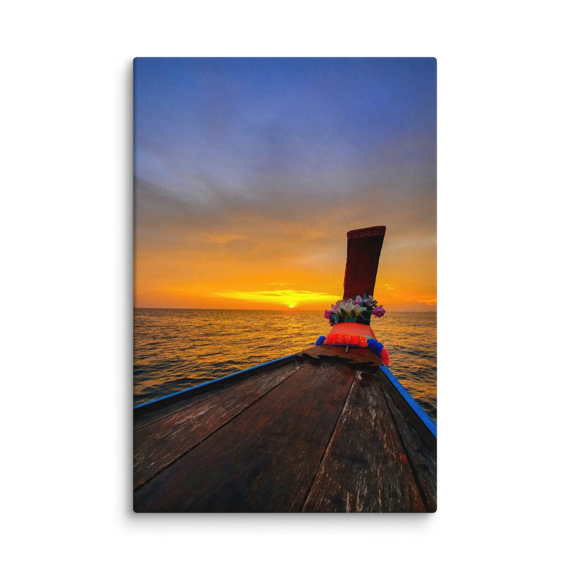 Ornate longtail boat bow with floral garlands facing golden sunset over calm sea in Thailand – tropical travel photography canvas print wall art decor