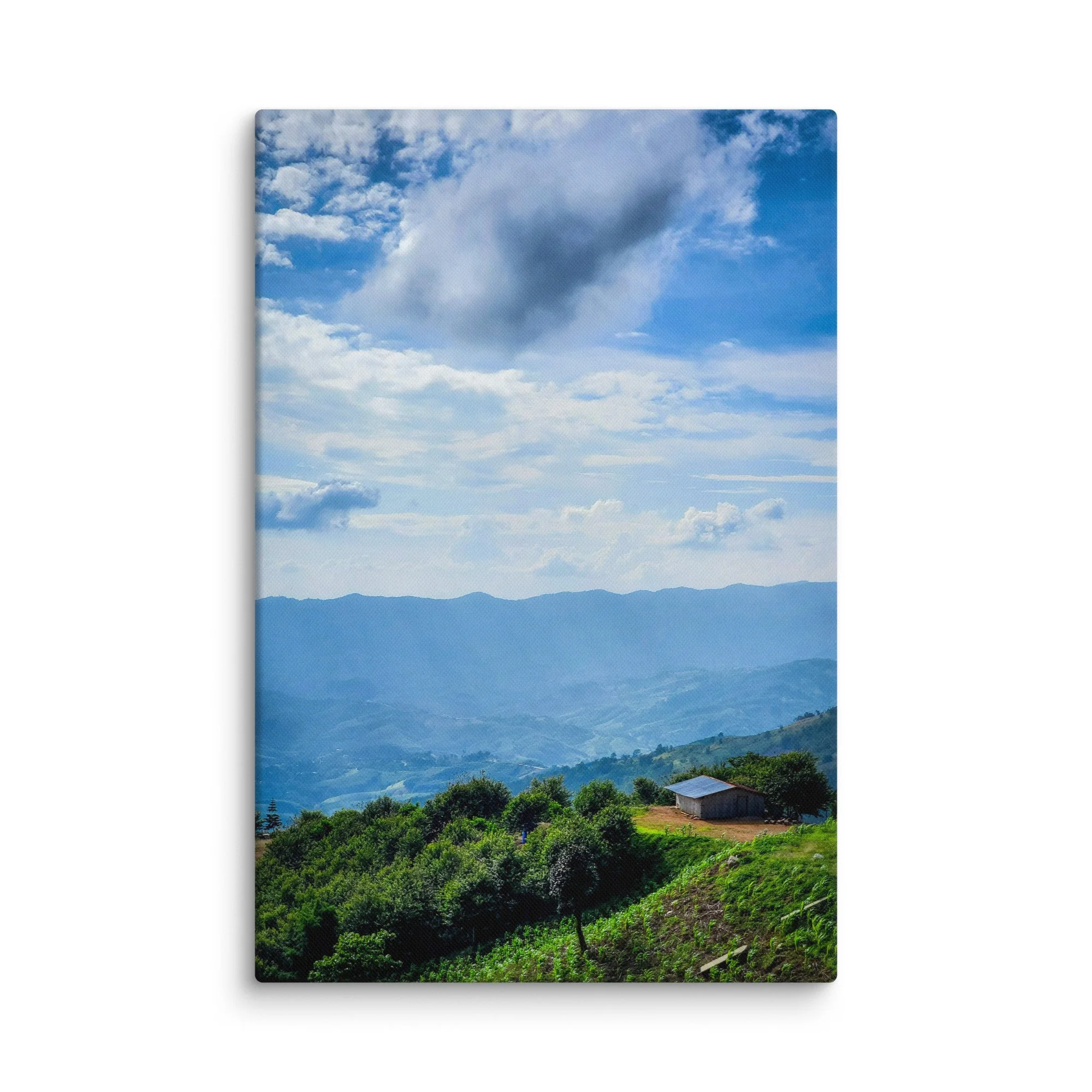 Panoramic view of misty green valleys and layered karst mountains with a small house in northern Vietnam (Hà Giang) under dramatic sky – highland travel photography canvas print wall art