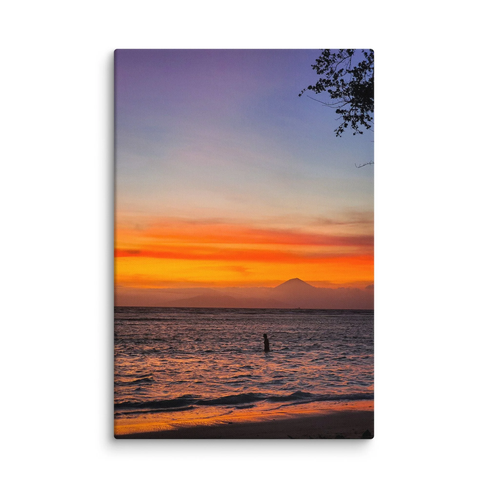 Silhouette of a person standing in the sea at sunset with Mount Rinjani (or Agung) volcano in the background in Indonesia – tropical travel photography canvas print wall art decor