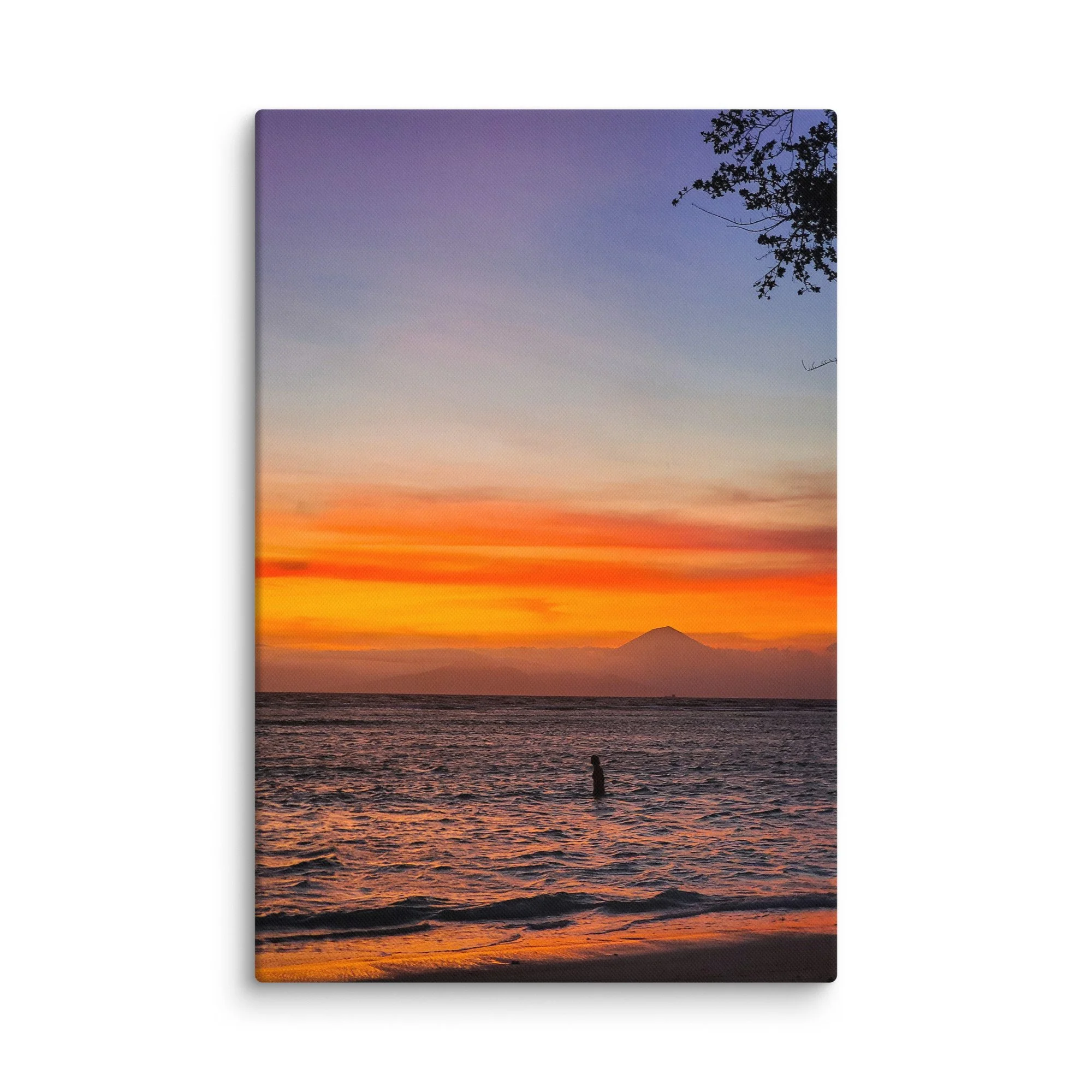 Silhouette of a person standing in the sea at sunset with Mount Rinjani (or Agung) volcano in the background in Indonesia – tropical travel photography canvas print wall art decor
