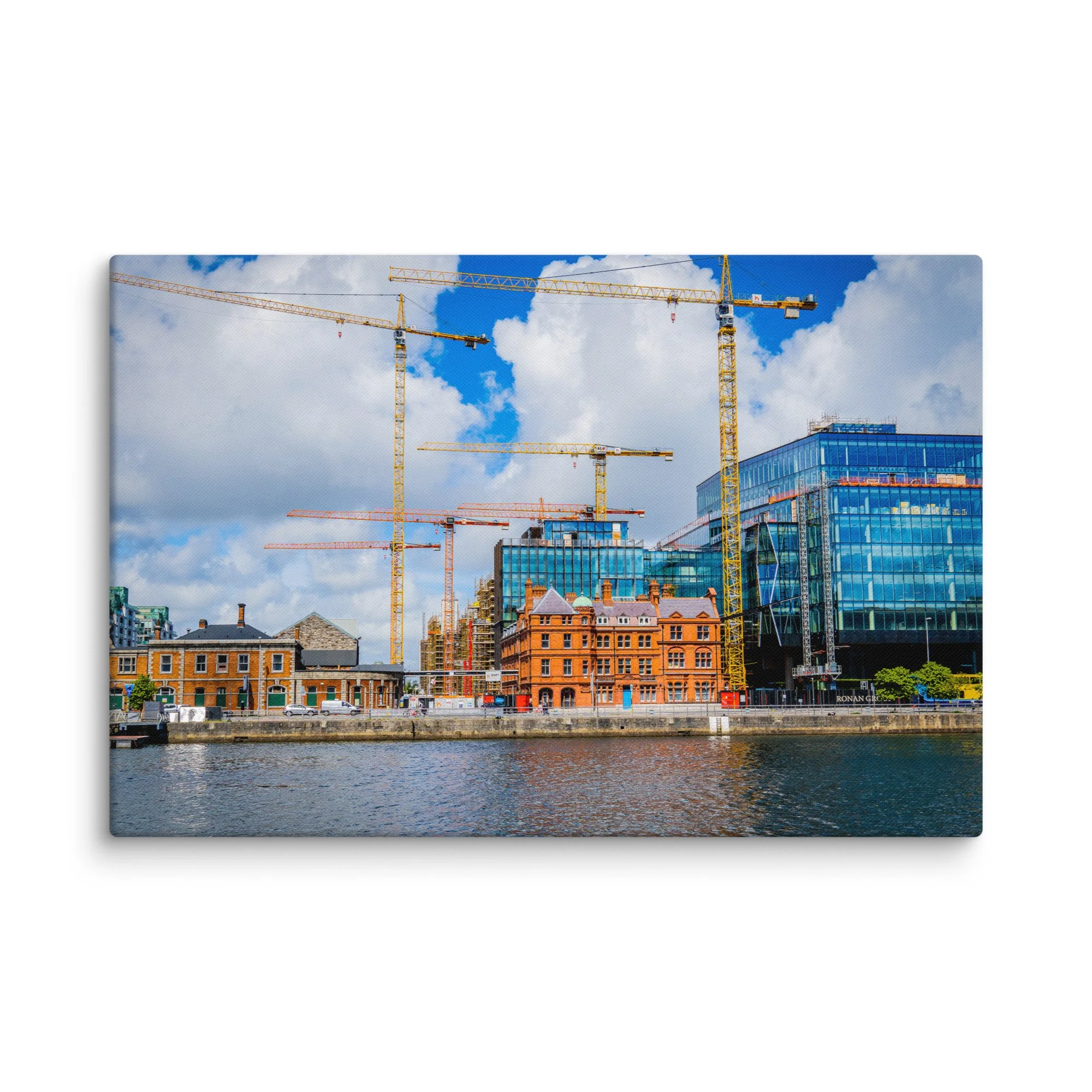 Vibrant view of Dublin’s Grand Canal Dock with yellow cranes, modern glass buildings, historic warehouses and calm water under blue sky – Irish urban travel photography canvas print