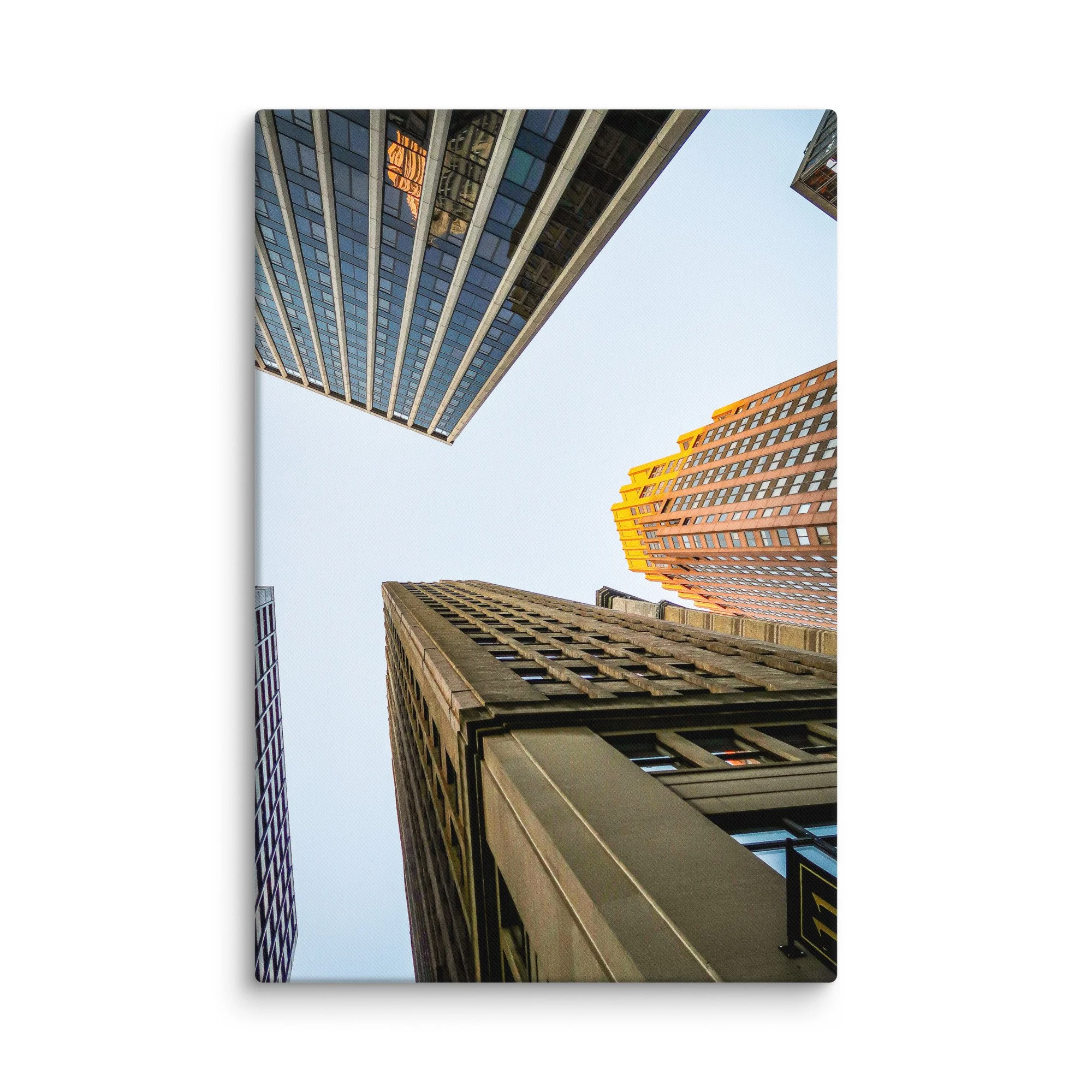 Dramatic upward view of towering skyscrapers in Wall Street, New York City, with golden light and blue sky – urban travel photography canvas print wall art decor
