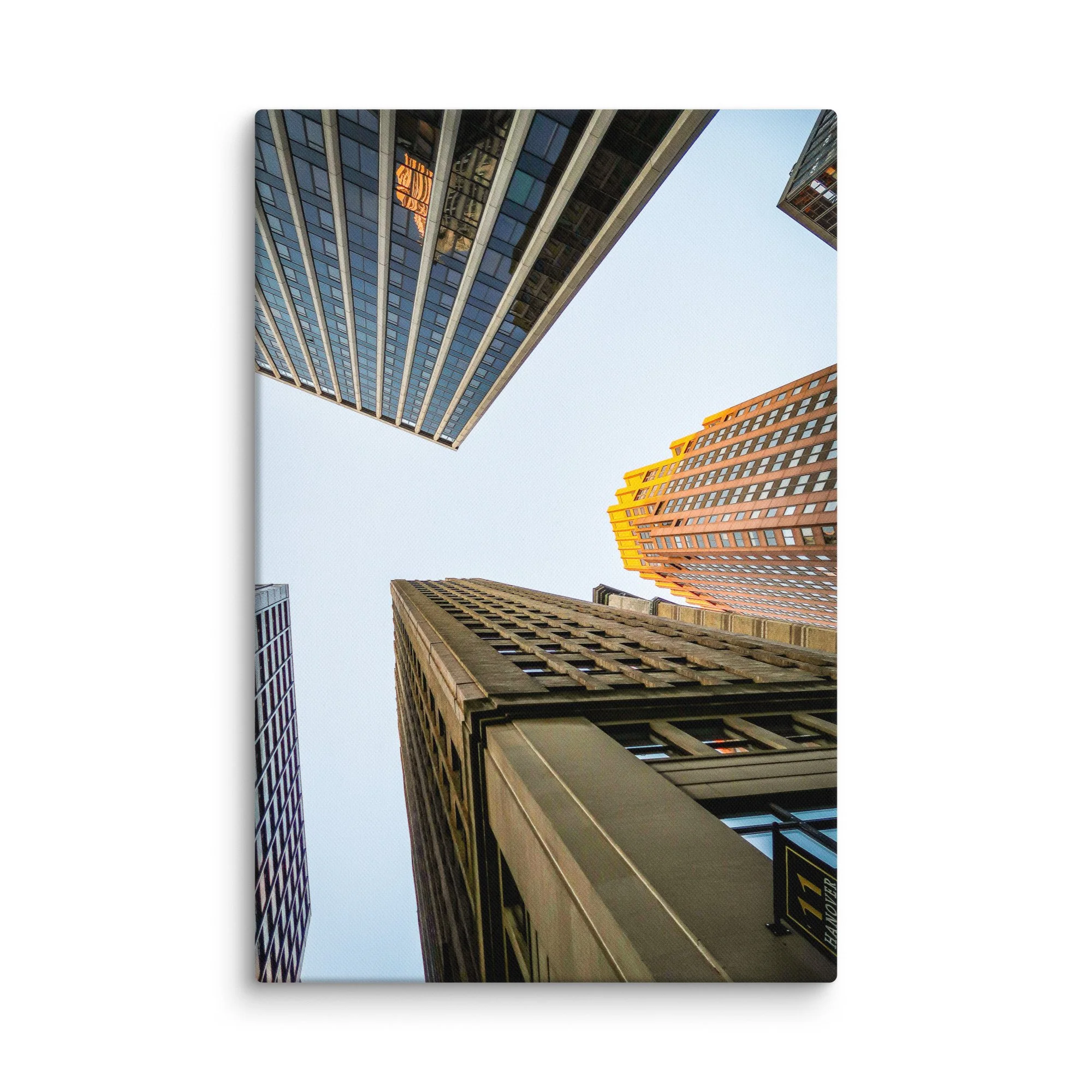 Dramatic upward view of towering skyscrapers in Wall Street, New York City, with golden light and blue sky – urban travel photography canvas print wall art decor