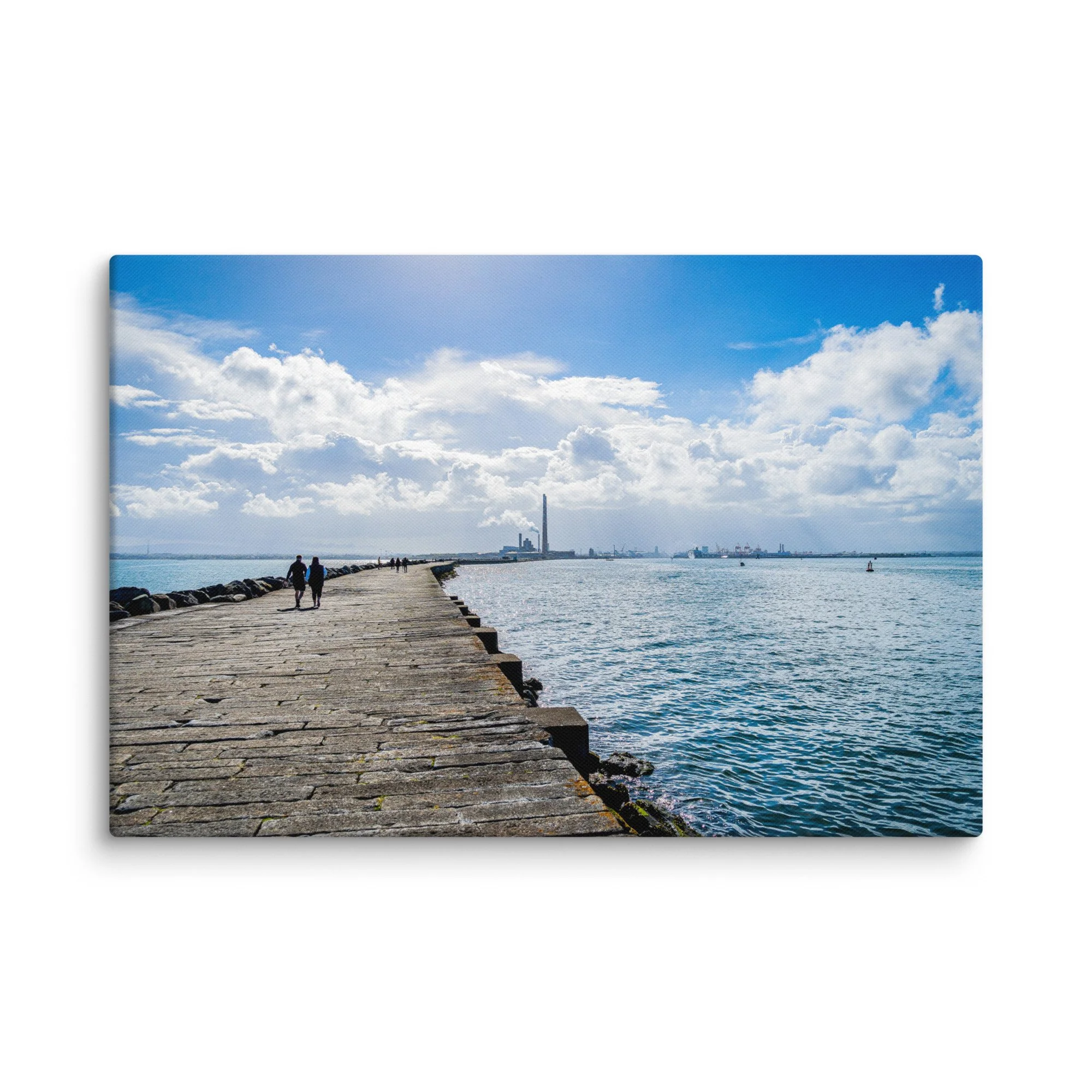 Long stone pier of the Great South Wall in Dublin Bay, Ireland with people walking toward Poolbeg chimneys under bright blue sky – Celtic coastal travel photography canvas print wall art