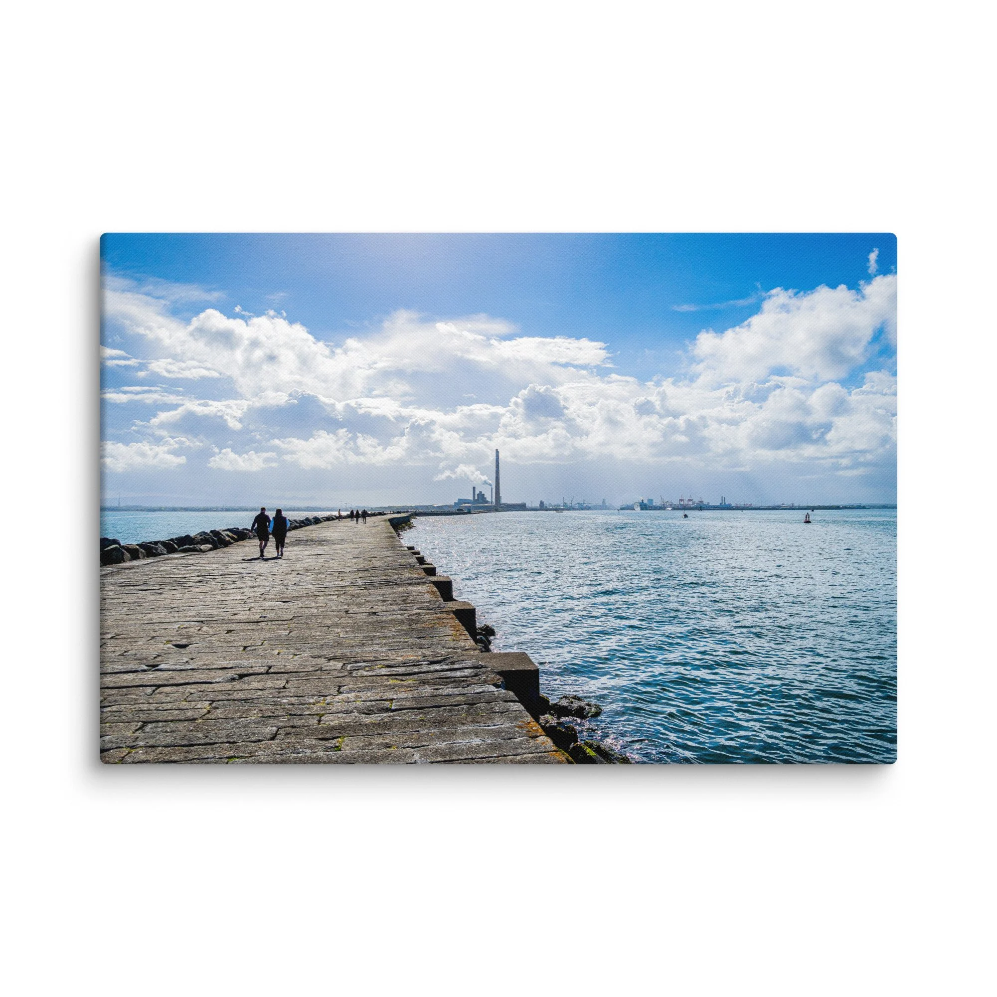 Long stone pier of the Great South Wall in Dublin Bay, Ireland with people walking toward Poolbeg chimneys under bright blue sky – Celtic coastal travel photography canvas print wall art
