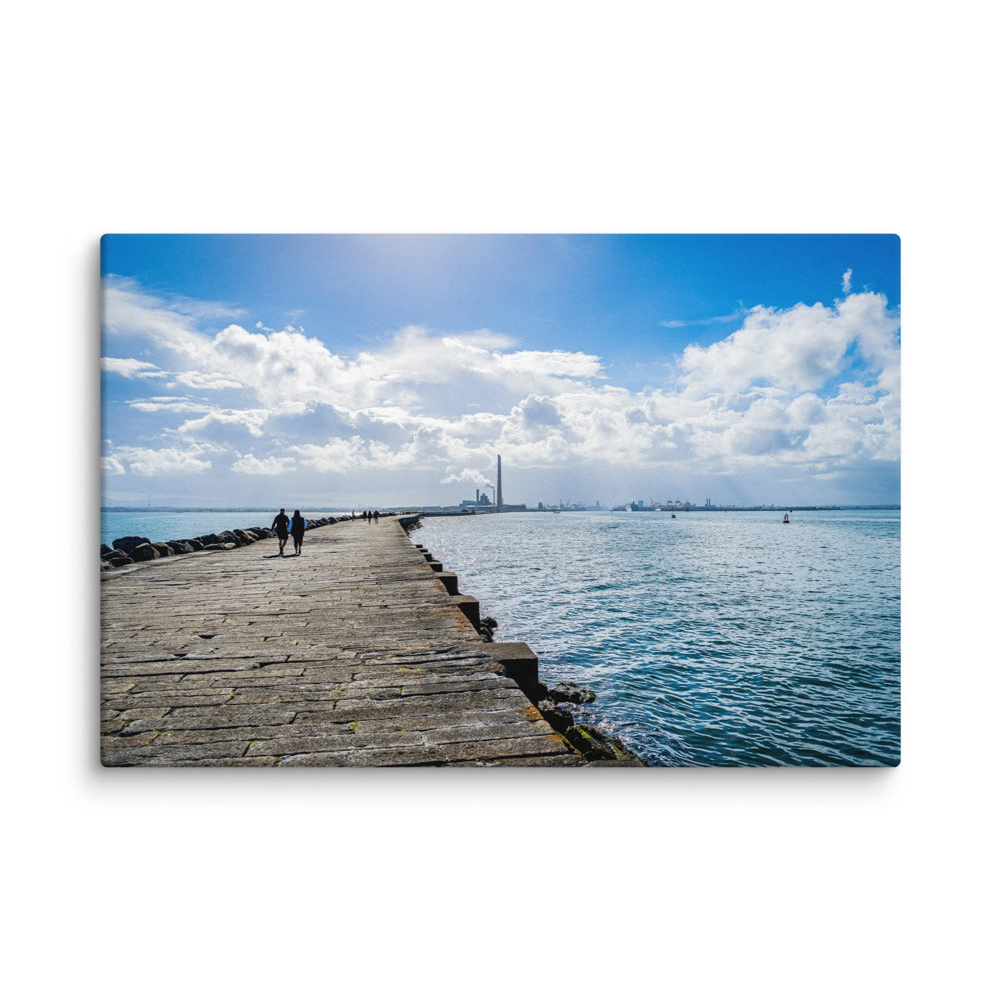 Long stone pier of the Great South Wall in Dublin Bay, Ireland with people walking toward Poolbeg chimneys under bright blue sky – Celtic coastal travel photography canvas print wall art