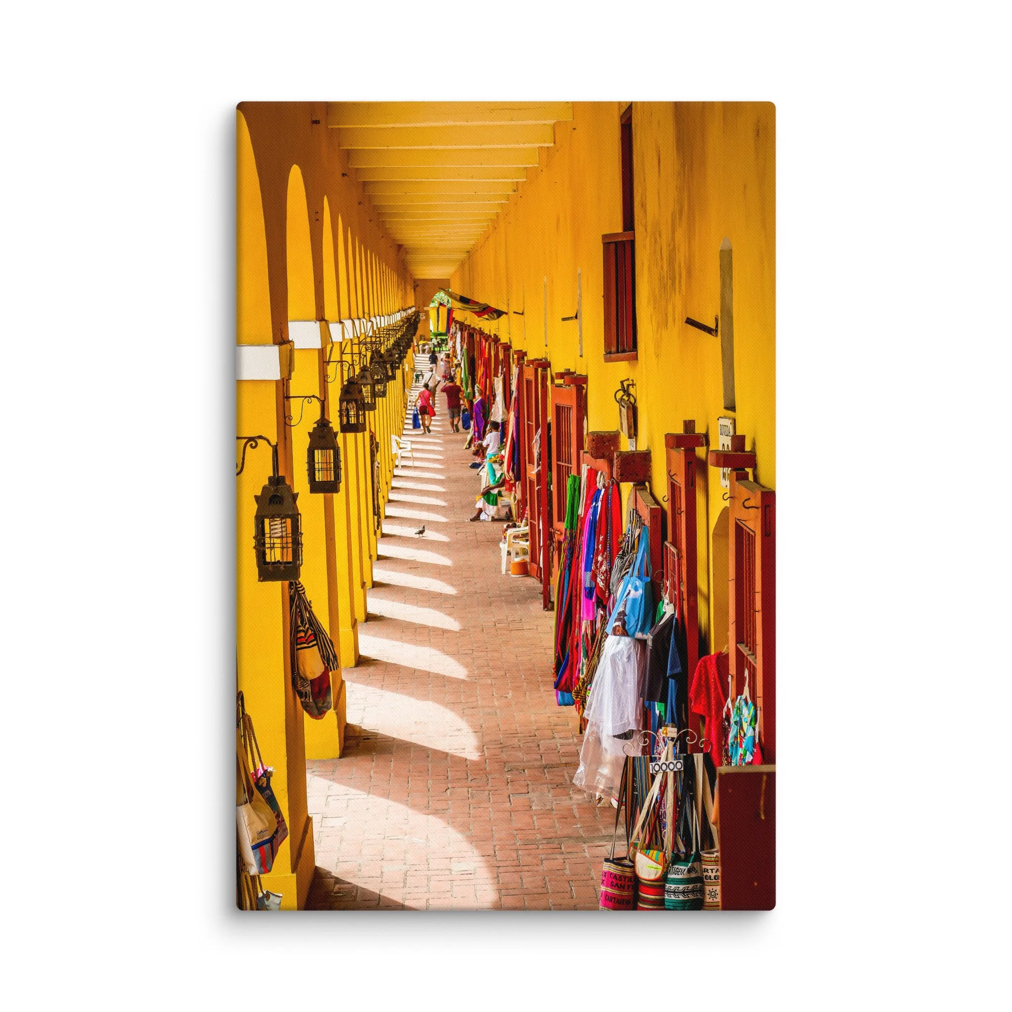 Vibrant yellow colonial arcade in Cartagena, Colombia with hanging lanterns, colorful bags and tourists strolling – Caribbean travel photography canvas print wall art decor