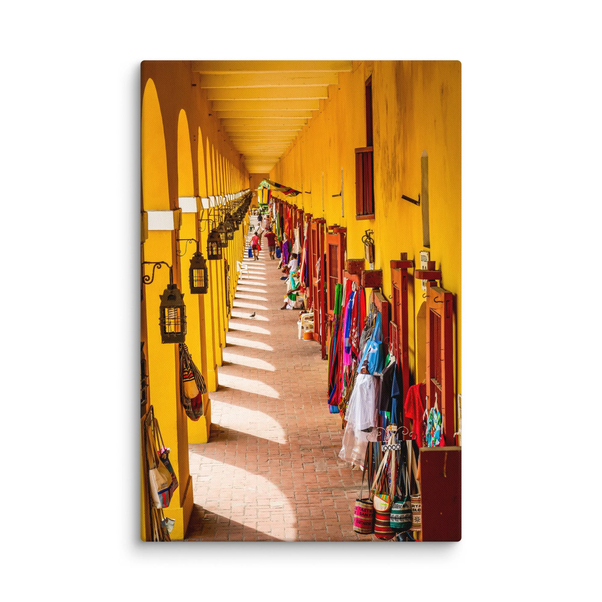 Vibrant yellow colonial arcade in Cartagena, Colombia with hanging lanterns, colorful bags and tourists strolling – Caribbean travel photography canvas print wall art decor
