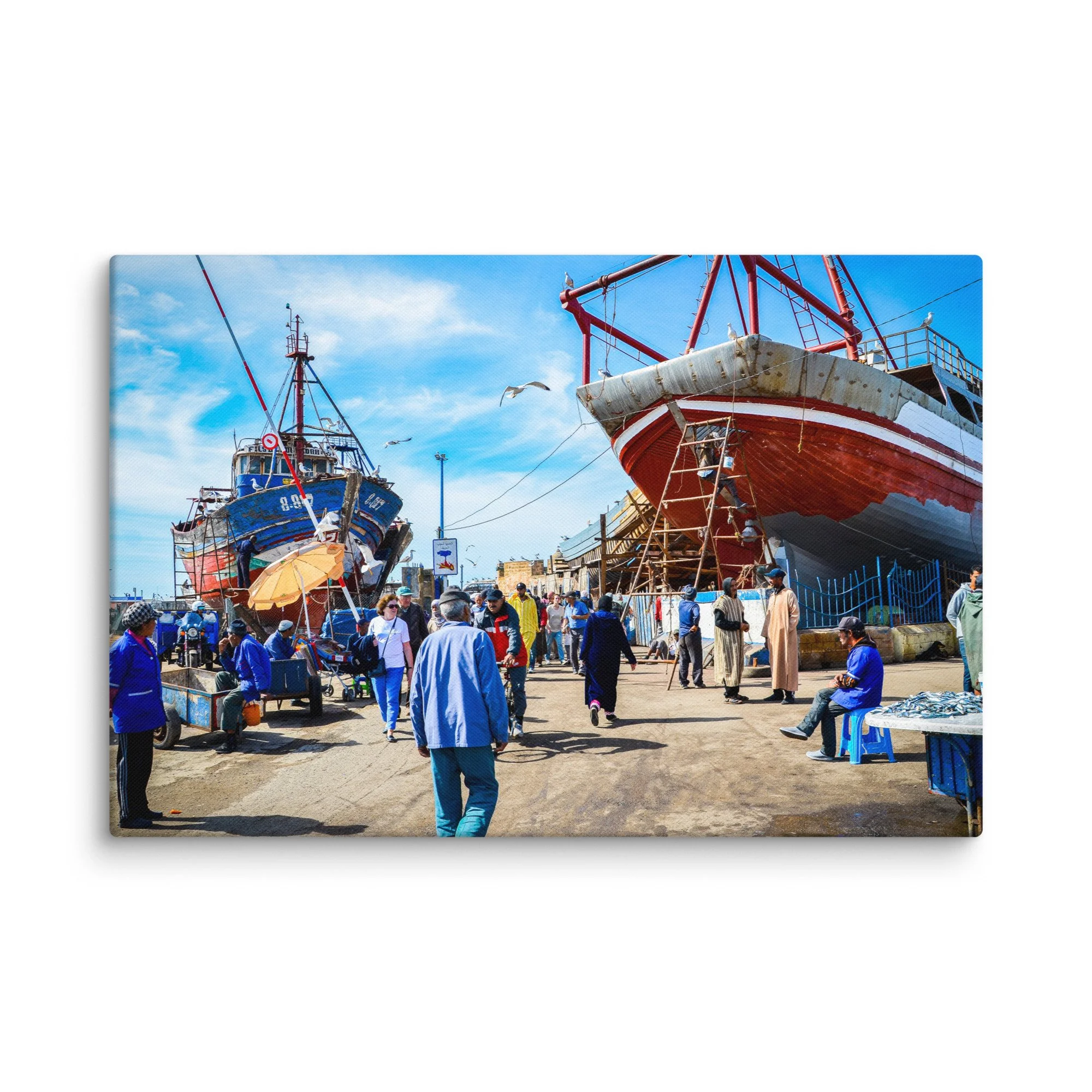 Vibrant fishing harbor in Essaouira, Morocco with colorful wooden boats, locals and seagulls under bright blue sky – Atlantic coastal travel photography canvas print wall art decor