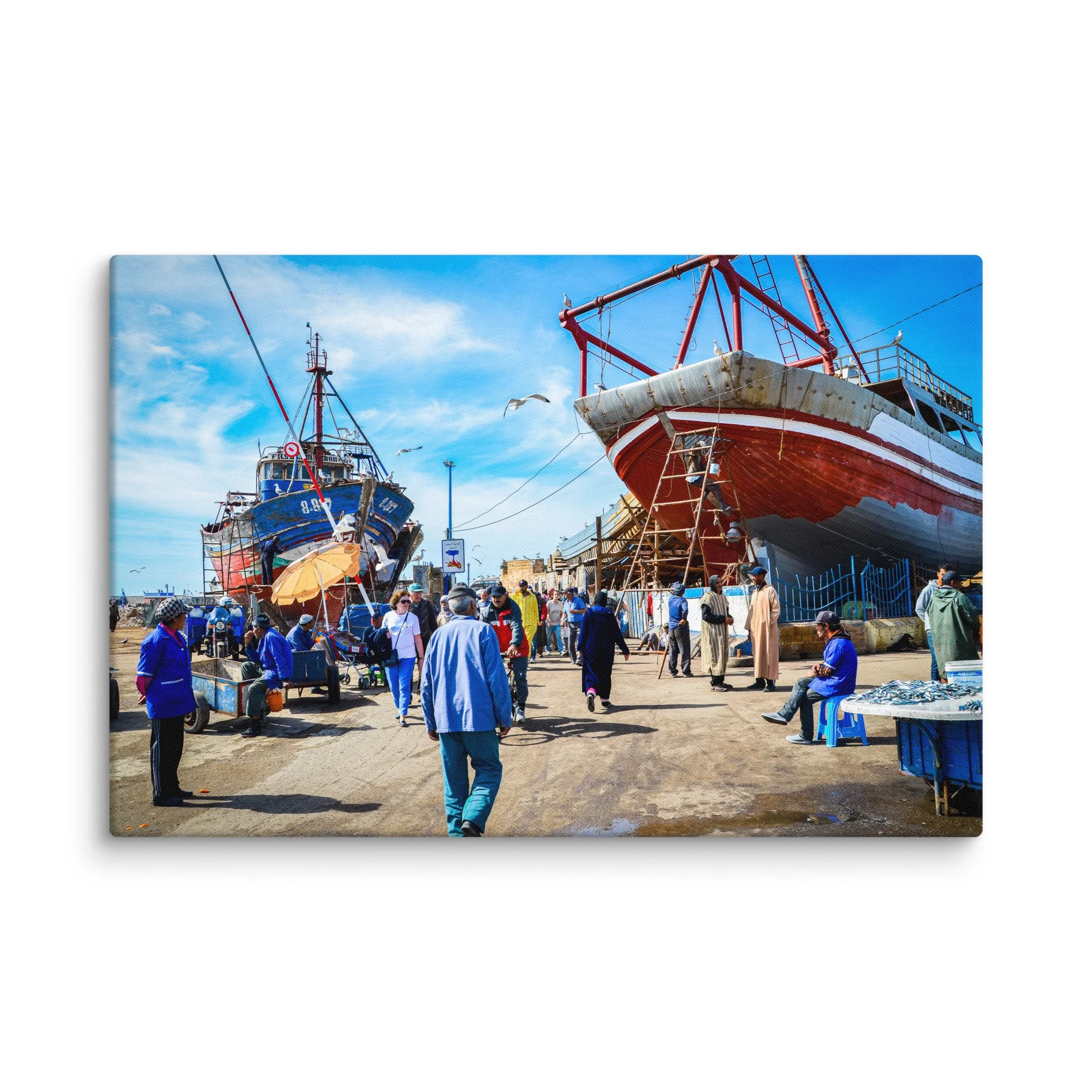 Vibrant fishing harbor in Essaouira, Morocco with colorful wooden boats, locals and seagulls under bright blue sky – Atlantic coastal travel photography canvas print wall art decor