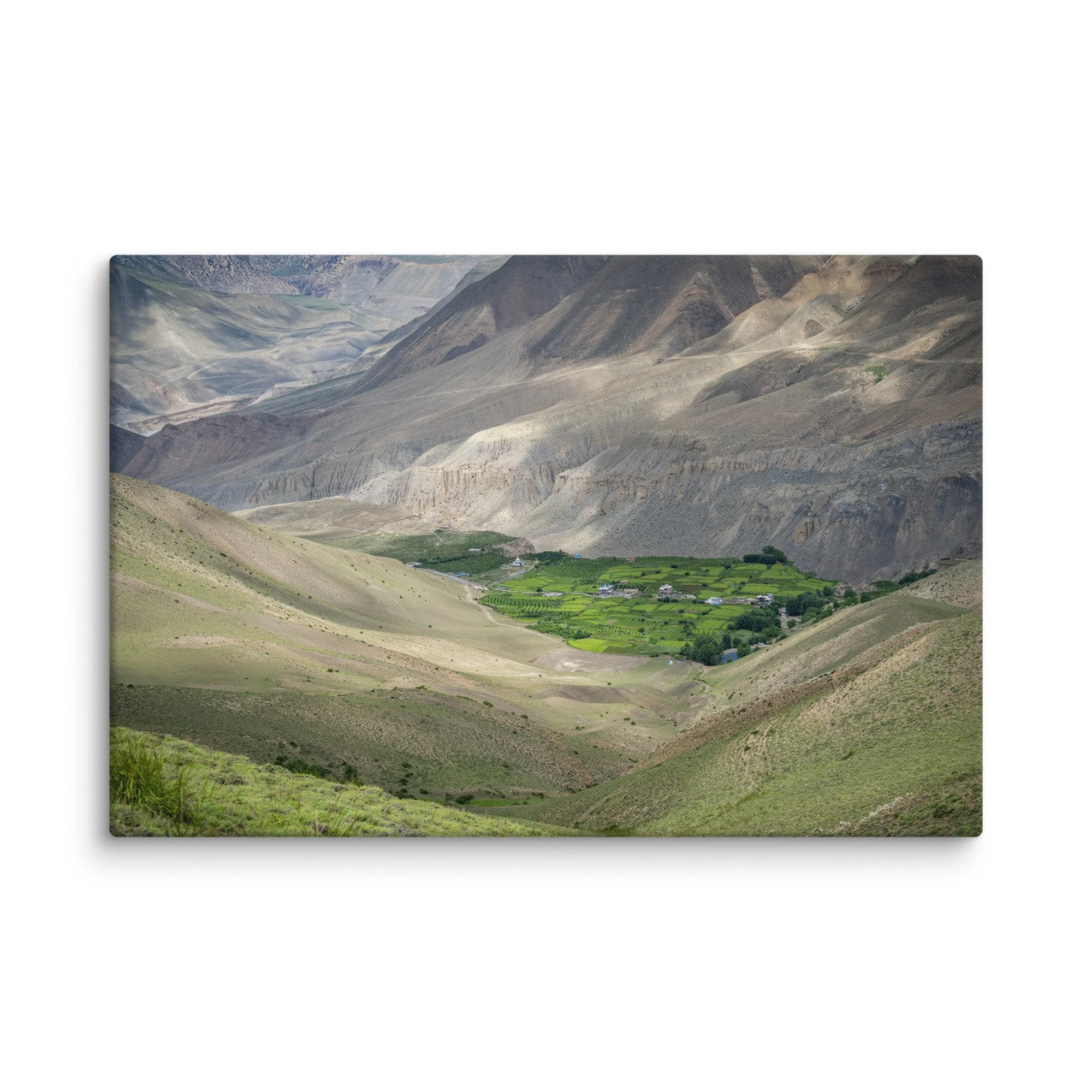 Lush green valley village with terraced fields and stone houses nestled in the dramatic mountains of the Annapurna Circuit, Nepal – Himalayan trekking travel photography canvas print