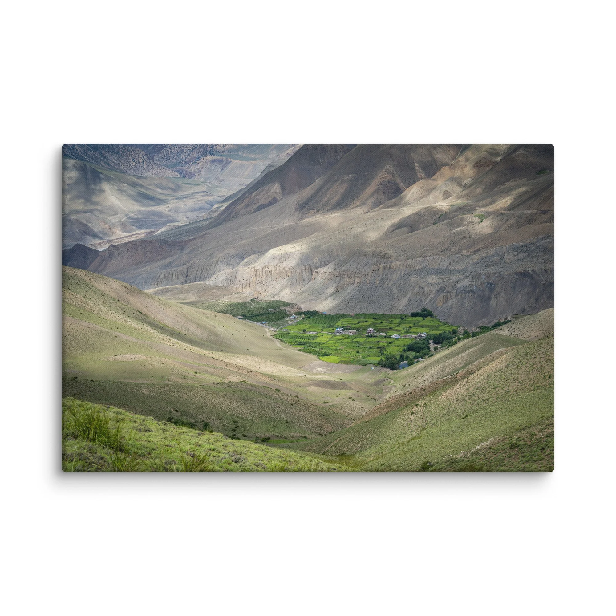 Lush green valley village with terraced fields and stone houses nestled in the dramatic mountains of the Annapurna Circuit, Nepal – Himalayan trekking travel photography canvas print