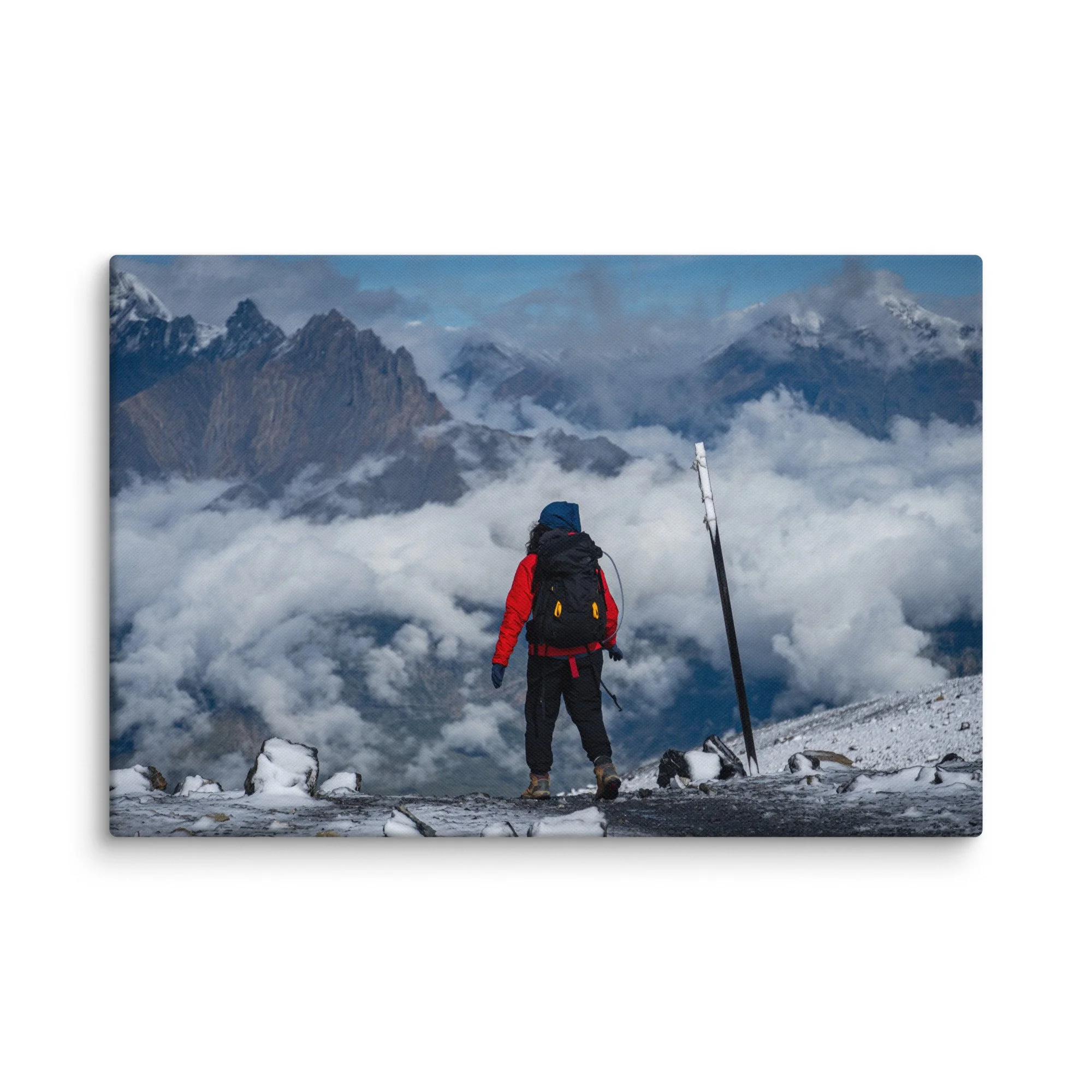 Lone trekker standing at Thorong La Pass on the Annapurna Circuit, Nepal, overlooking dramatic Himalayan peaks and sea of clouds – high-altitude trekking travel photography canvas print
