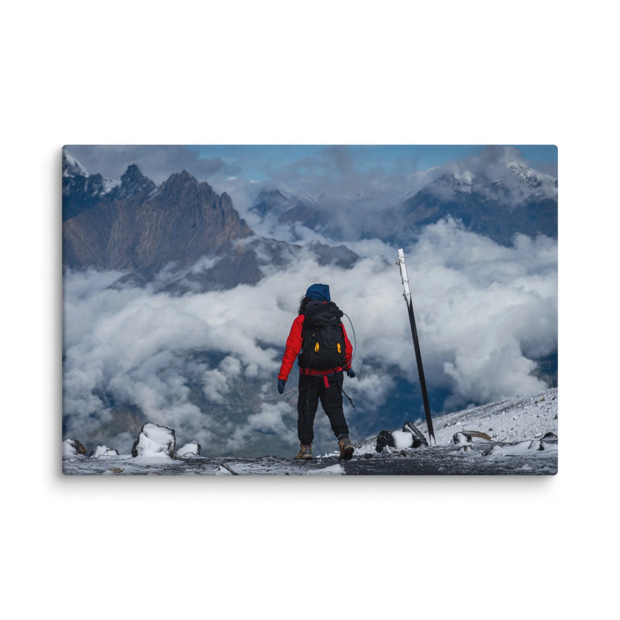 Lone trekker standing at Thorong La Pass on the Annapurna Circuit, Nepal, overlooking dramatic Himalayan peaks and sea of clouds – high-altitude trekking travel photography canvas print