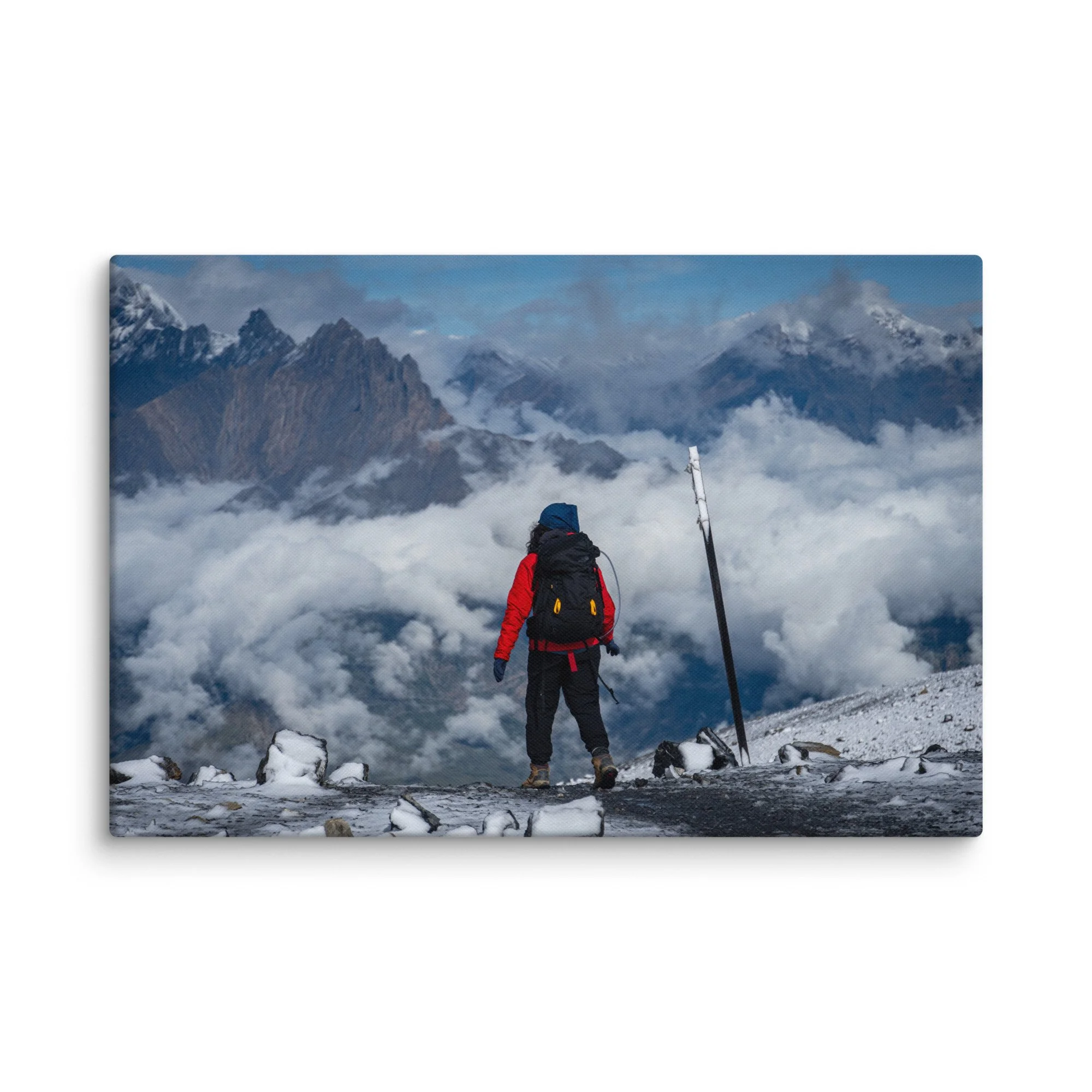 Lone trekker standing at Thorong La Pass on the Annapurna Circuit, Nepal, overlooking dramatic Himalayan peaks and sea of clouds – high-altitude trekking travel photography canvas print