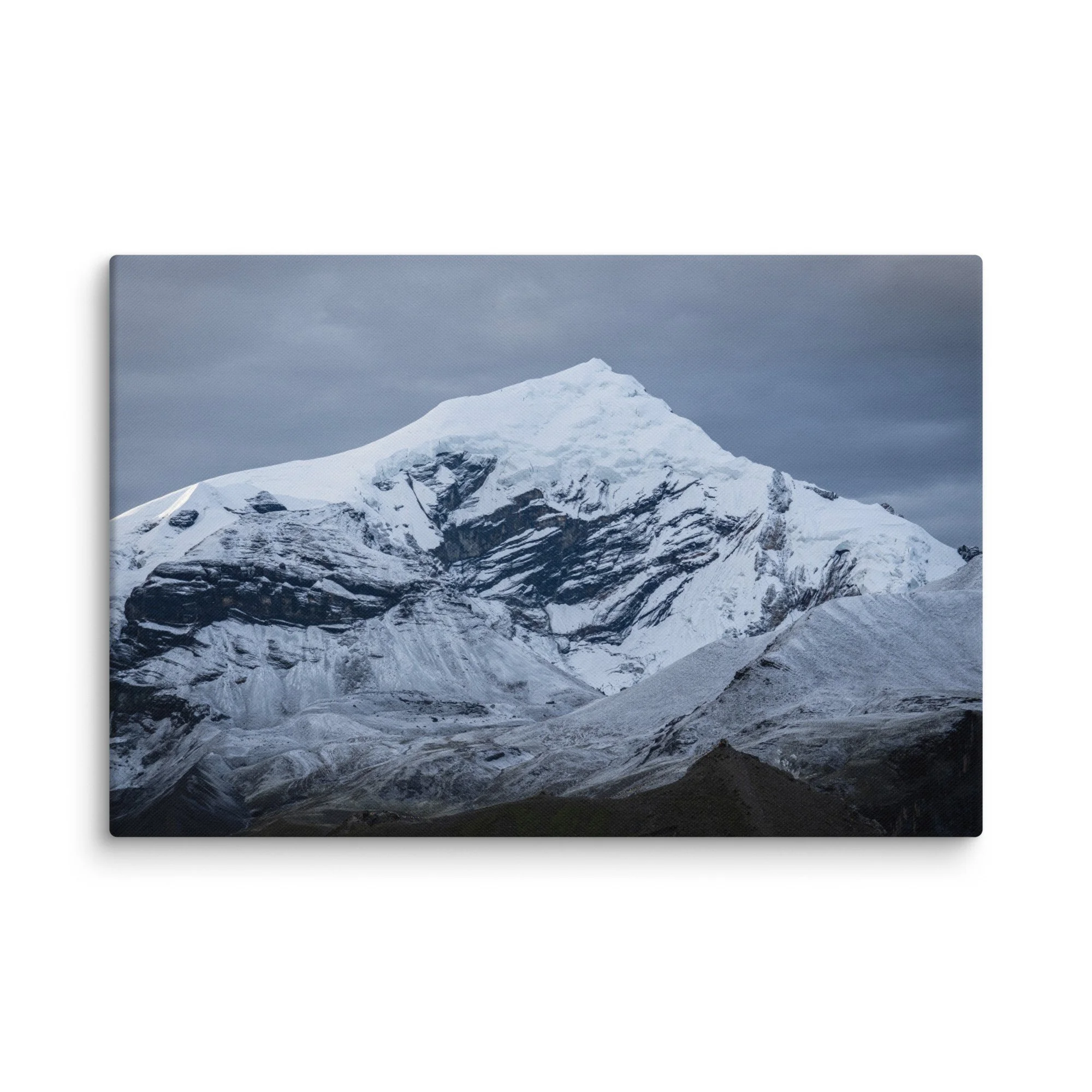Snow-covered Himalayan summit on the Annapurna Circuit, Nepal with dramatic ridges and moody sky – high-altitude trekking travel photography canvas print wall art decor