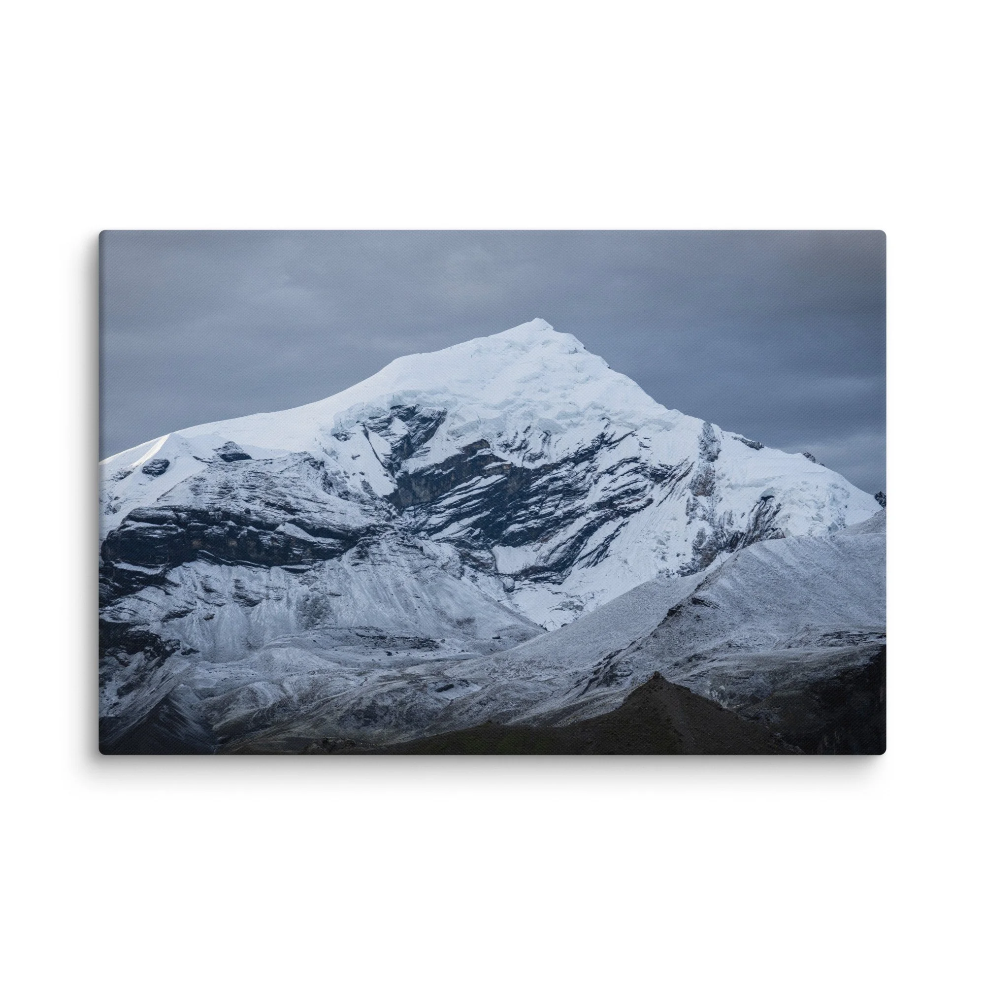 Snow-covered Himalayan summit on the Annapurna Circuit, Nepal with dramatic ridges and moody sky – high-altitude trekking travel photography canvas print wall art decor